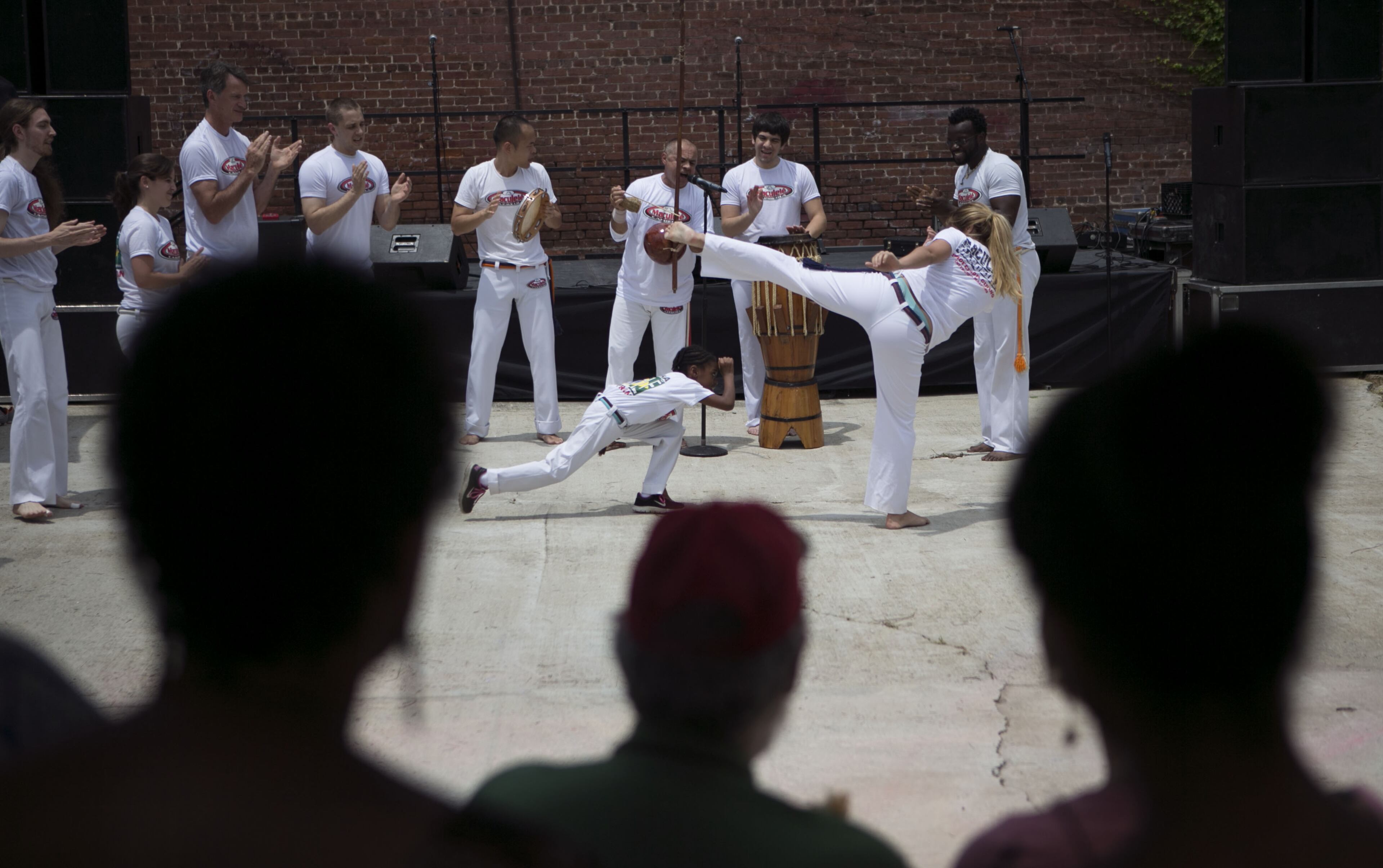 Kiley Domineck (age 8, left) & Dandhara Silva demonstrated Maculele Brazilian Martial Arts with the Capoeira group. The Atlanta Regional Commission and experts in the concept of "tactical urbanism" transformed two blocks of Auburn Avenue in the Old Fourth Ward of Atlanta into a place that allowed young & old to live feel & age in place on Sunday June 22, 2014. The Sweet Auburn Living Beyond Expectations transformation was the culmination of a multi-year project by the ARC to demonstrate what it takes to build a community that appeals to older adults & Millennials. (Photo by Phil Skinner)