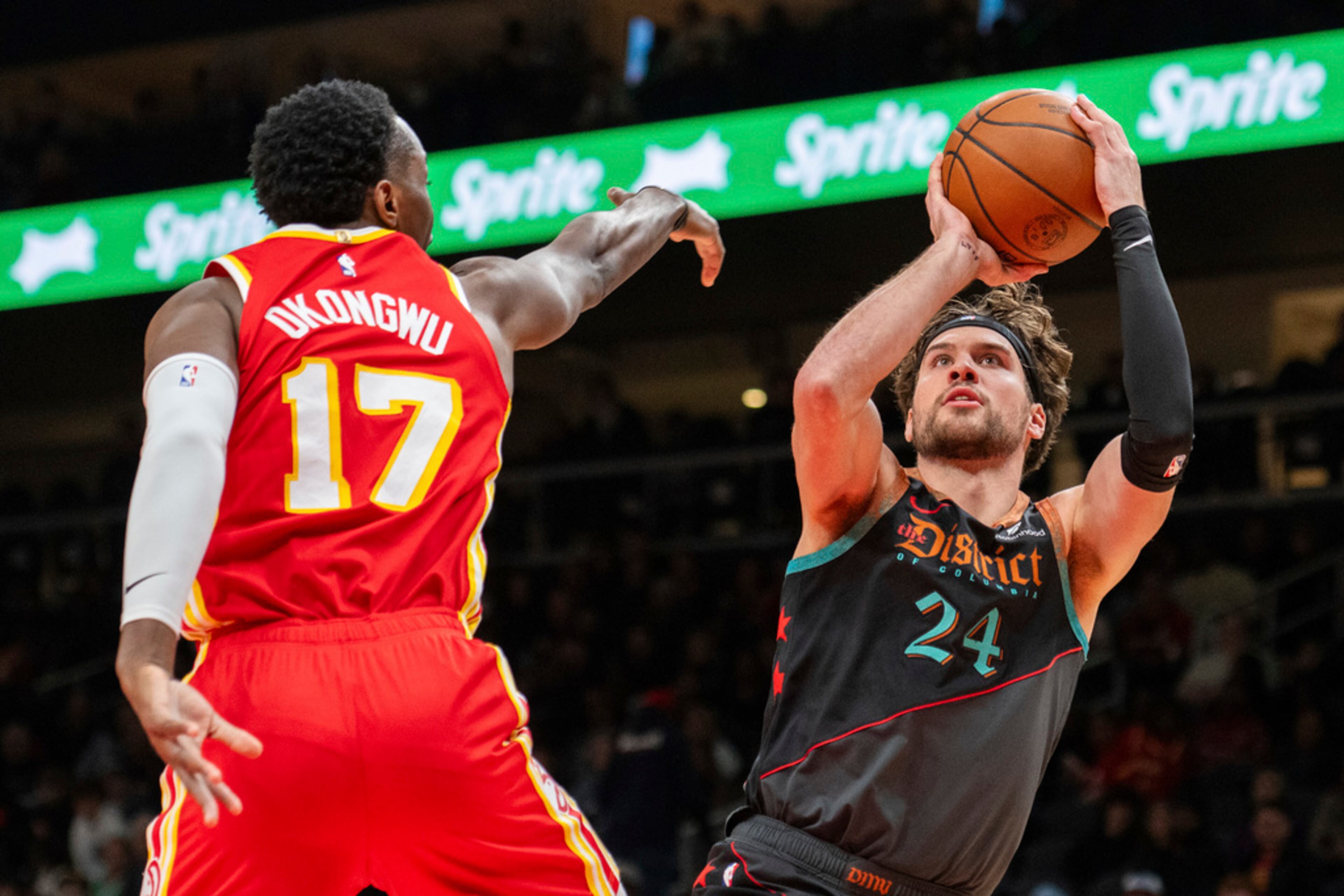 Washington Wizards forward Corey Kispert (24) shoots against Atlanta Hawks forward Onyeka Okongwu (17) during the first half of an NBA basketball game Saturday, Jan 13, 2024, in Atlanta. (AP Photo/Hakim Wright Sr.)