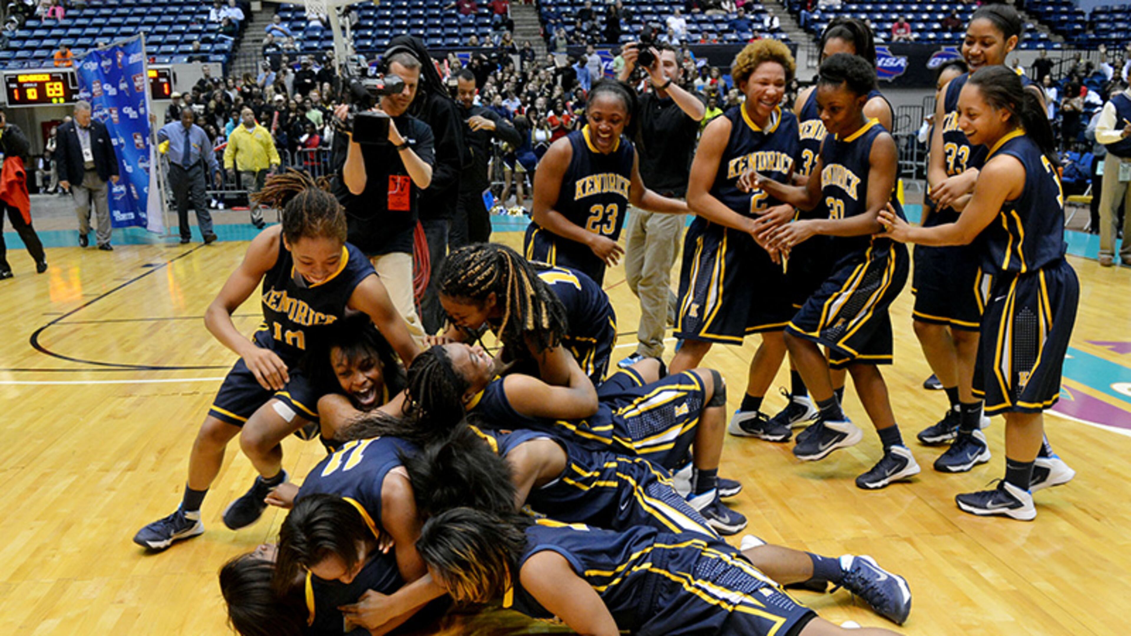 MARCH 6, 2014 MACON Kendrick Cherokees players celebrate their win on the court after the game. Coverage of the Class AA girls basketball championship between Wesleyan Wolves and Kendrick Cherokees at the Macon Coliseum Friday, March 7, 2014. Kendrick won, knocking off the Wesleyan Wolves, 69-58. KENT D. JOHNSON / KDJOHNSON@AJC.COM Kendrick Cherokees players celebrate their win on the court after defeating Wesleyan 69-58 for the Class AA girls state tile Friday, March 7, 2014, in Macon.