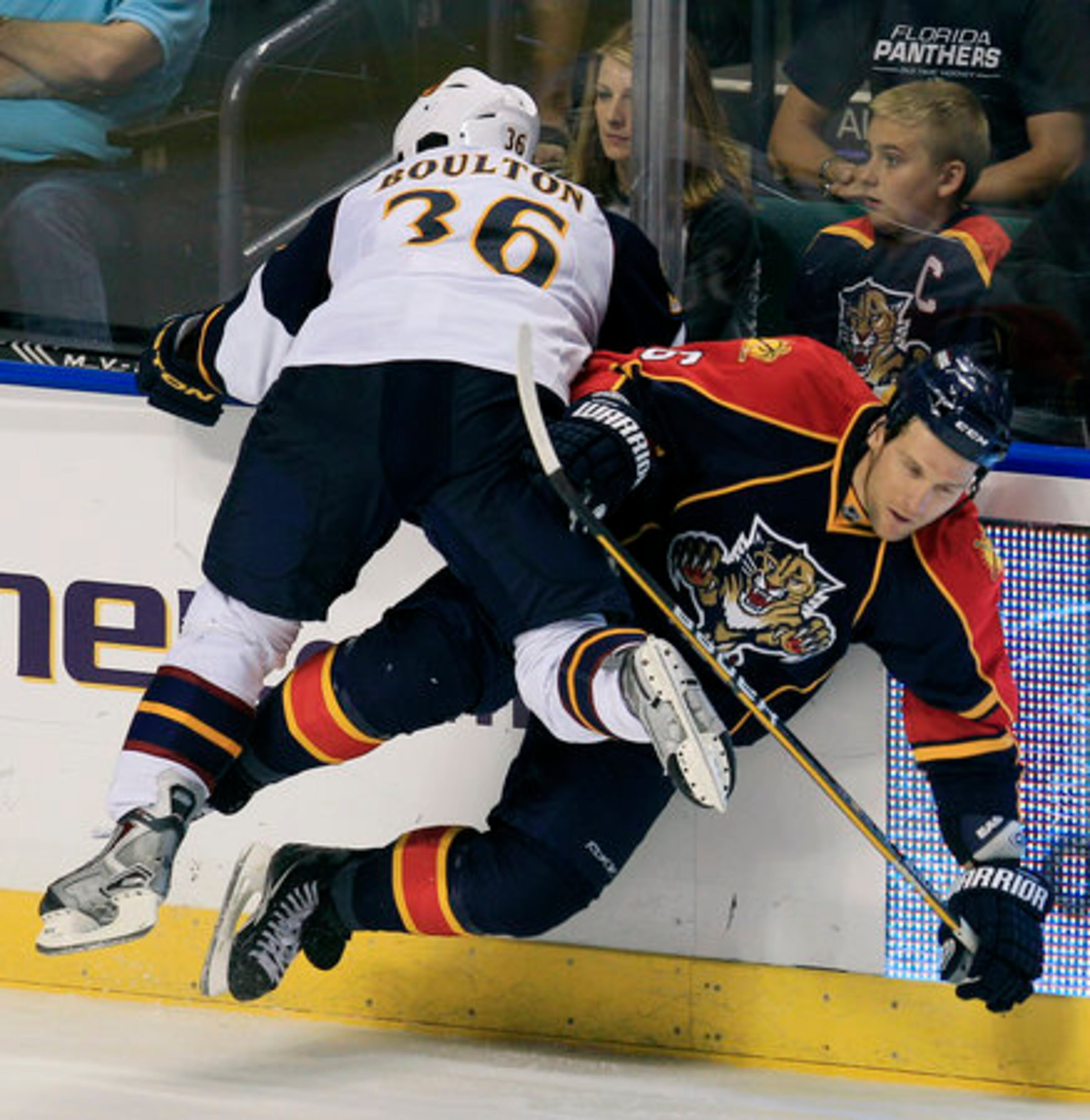 Atlanta Thrashers' Eric Boulton (36) and Florida Panthers' Dennis Wideman (6) collide during the third period of an NHL hockey game in Sunrise, Fla., Wednesday, Nov. 3, 2010. The Thrashers won 4-3.