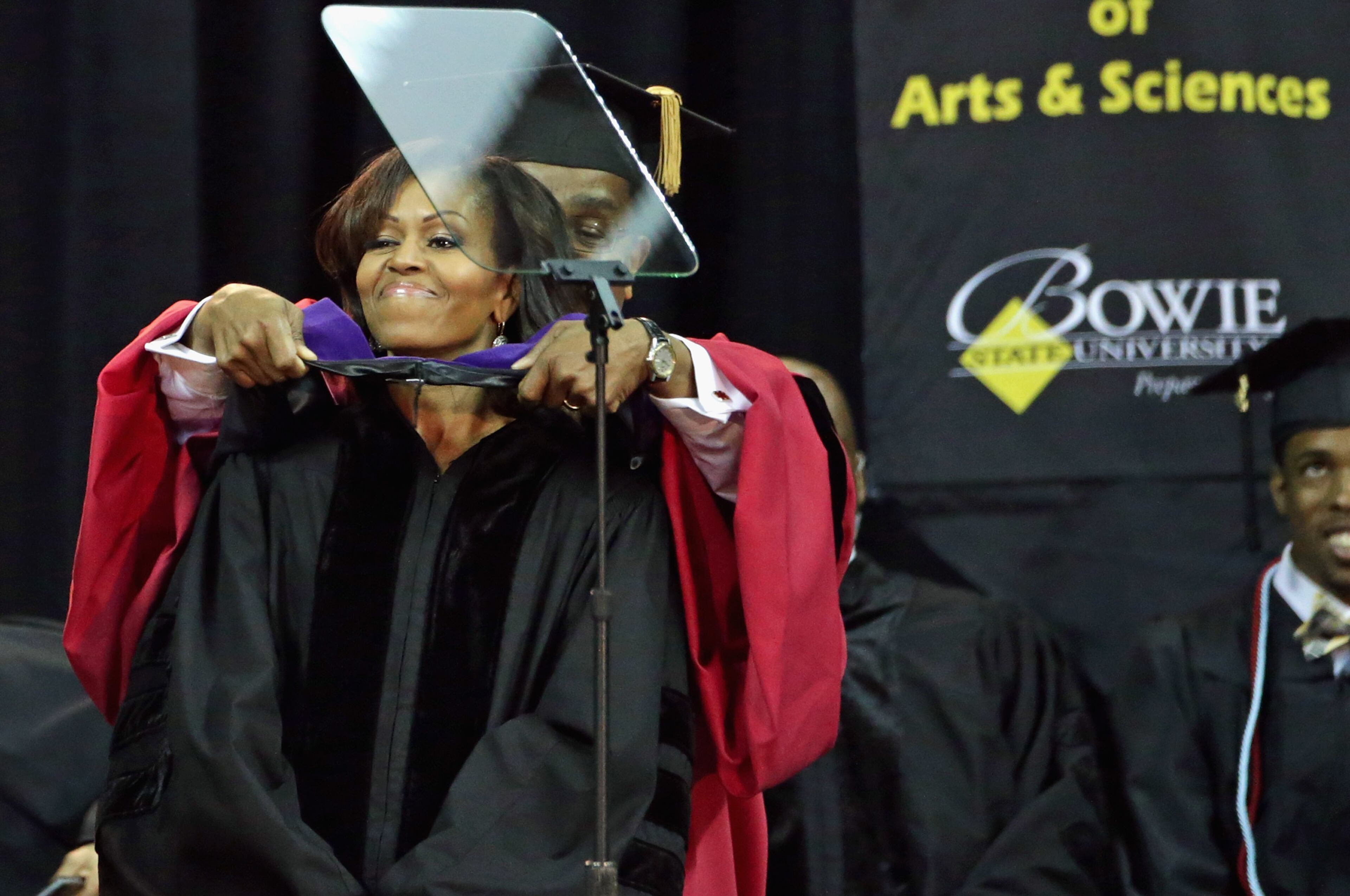 Bowie State University Provost Weldon Jackson places a doctoral hood on U.S. first lady Michelle Obama after she received an Honorary Doctor of Laws degree during the school's graduation ceremony at the Comcast Center on the campus of the University of Maryland May 17, 2013 in College Park, Maryland. Obama delivered the commencement speech for the 600 graduates of Maryland's oldest historically black university and one of the ten oldest in the country. (Photo by Chip Somodevilla/Getty Images)