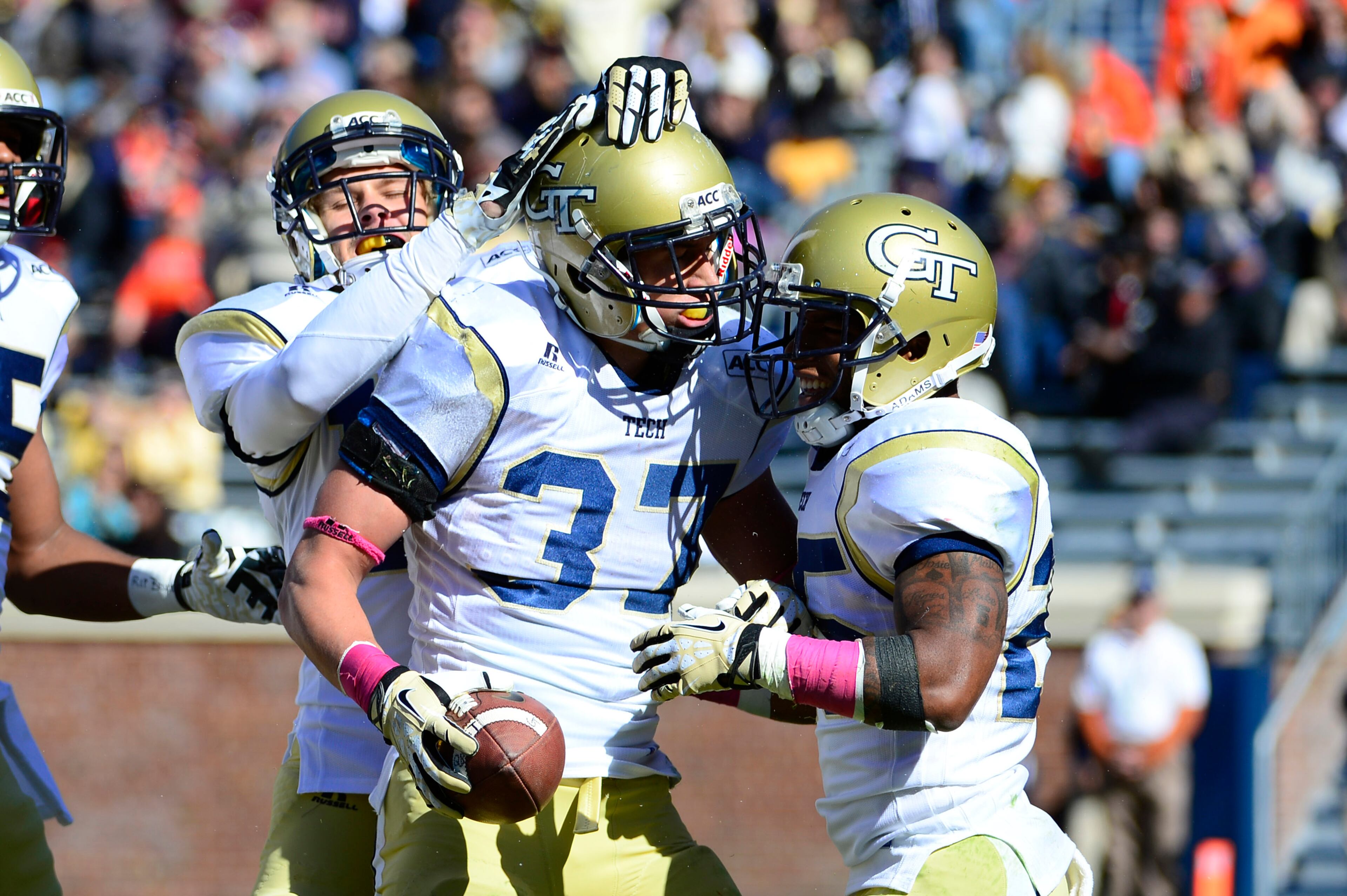 Georgia Tech Yellow Jackets running back Zach Laskey (37) celebrates with wide receiver Corey Dennis (16) and running back Robert Godhigh (25) after scoring a touchdown in the second quarter at Scott Stadium. Mandatory Credit: Bob Donnan-USA TODAY Sports
