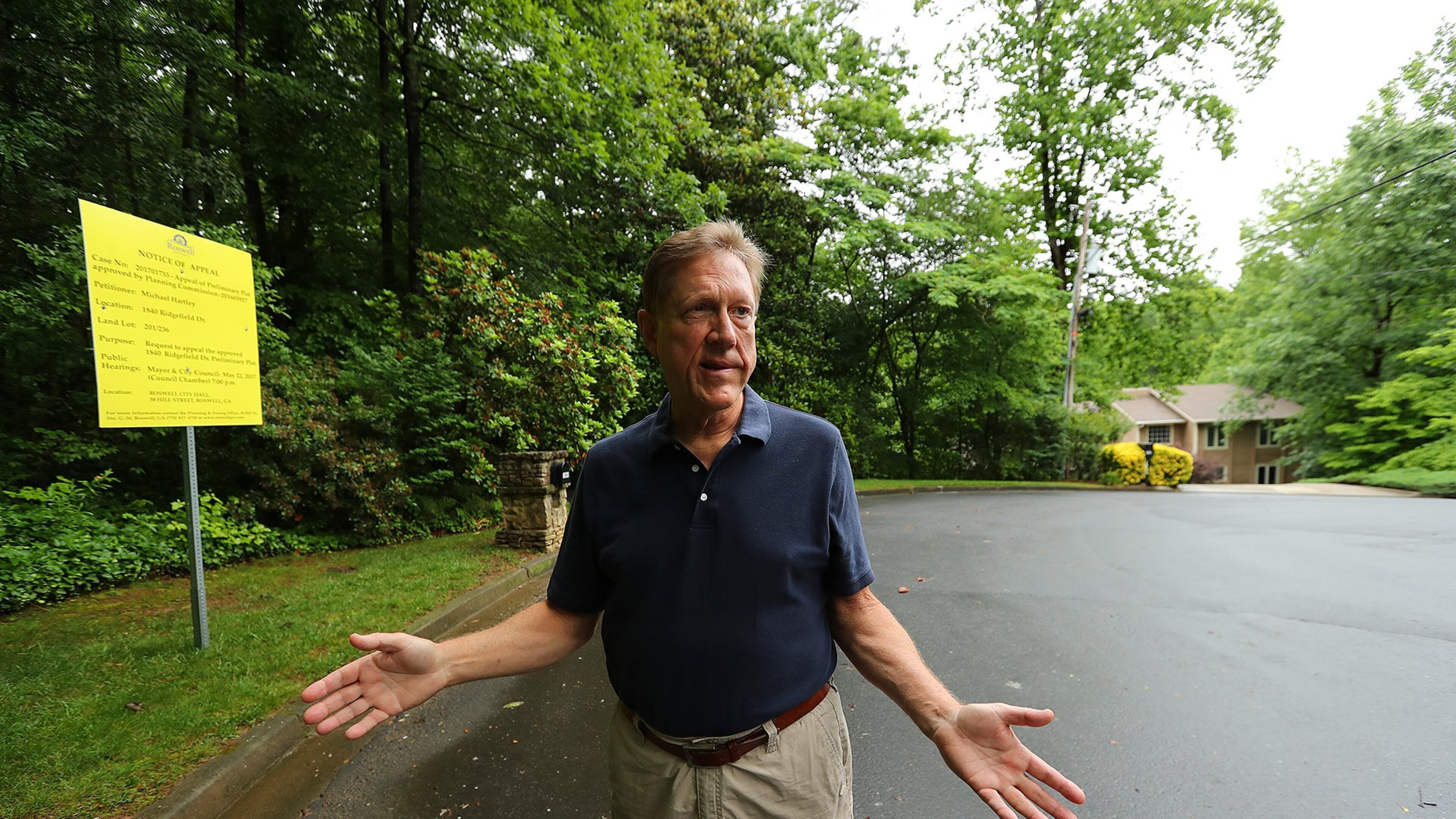 Michael Hartley stands beside the property his neighbor is trying to sell next door to his home on a cul-de-sac where a developer hopes to add around 20 new homes in Roswell. Curtis Compton/ccompton@ajc.com AJC FILE PHOTO