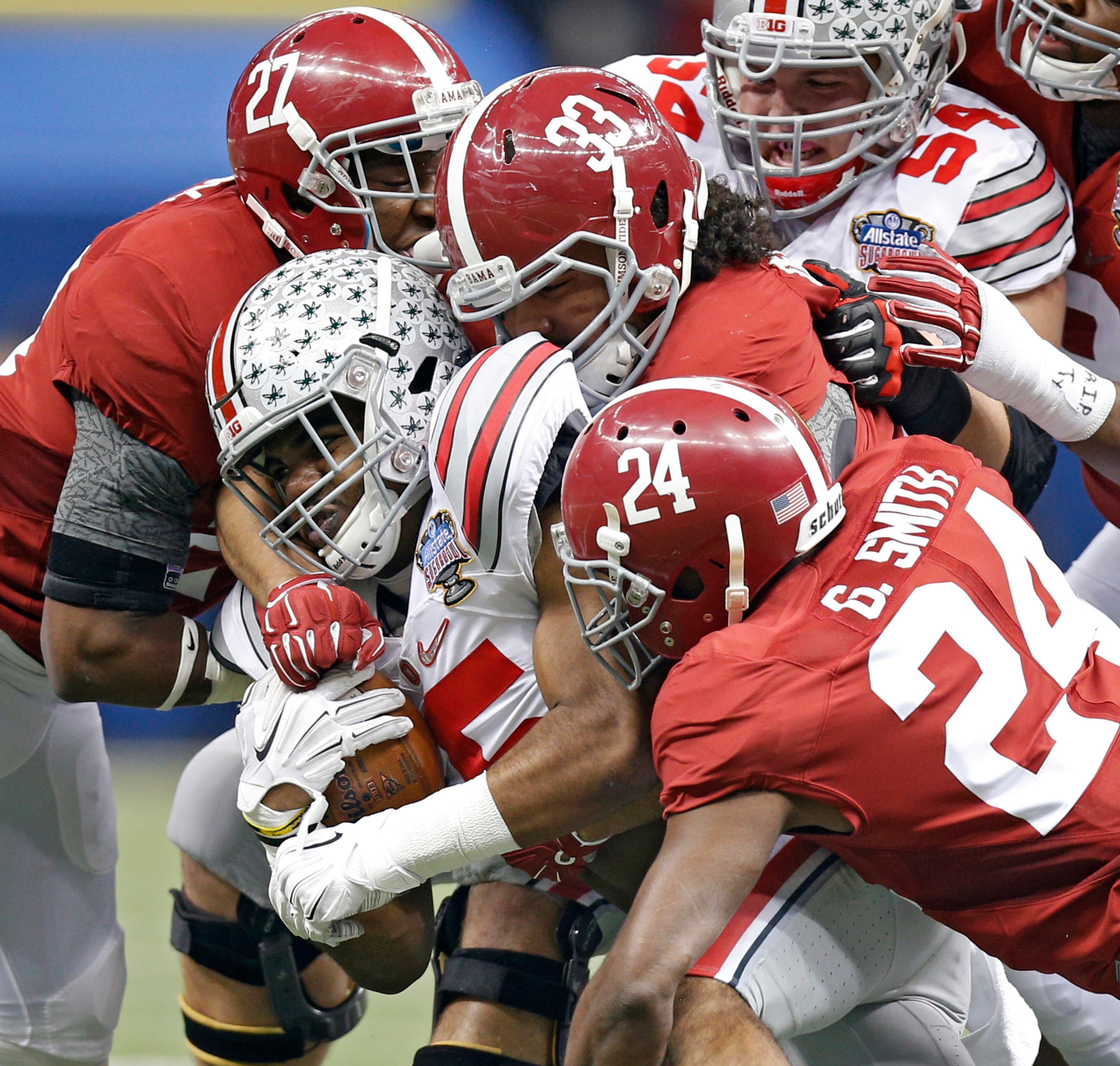 Alabama Crimson Tide linebacker Trey DePriest (33) tackles Ohio State Buckeyes running back Ezekiel Elliott (15) during the first quarter of the Allstate Sugar Bowl and College Football Playoff Semifinal on Thursday, Jan. 1, 2015 at Mercedes-Benz Superdome in New Orleans. (Kyle Robertson/Columbus Dispatch/TNS)