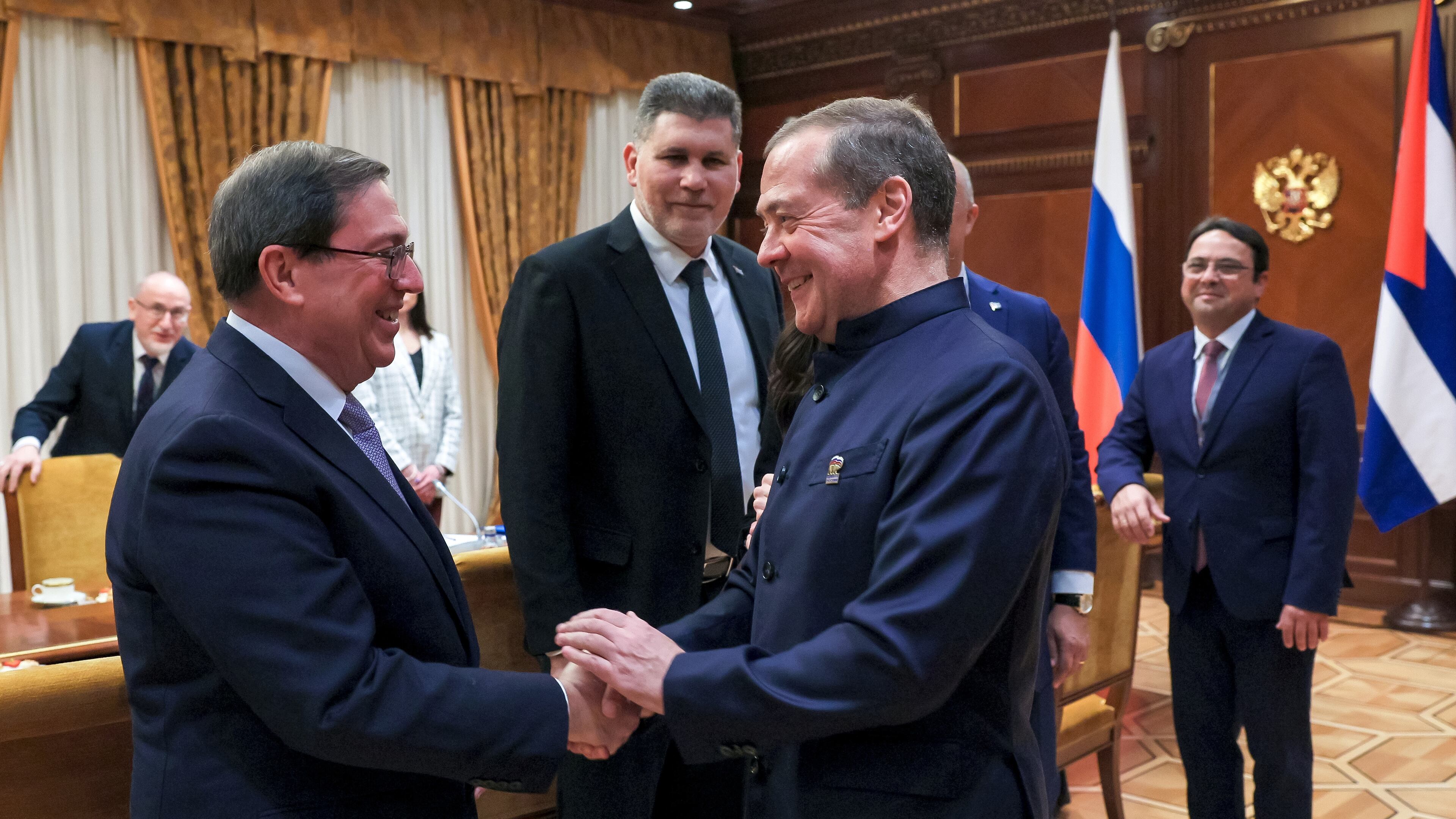 Cuban Foreign Minister Bruno Rodriguez, left, and Russian Security Council Deputy Chairman and the head of the United Russia party Dmitry Medvedev, foreground right, greet each other prior to their talks in Moscow, Wednesday, Feb. 18, 2026. (Ekaterina Shtukina, Sputnik Pool Photo via AP)