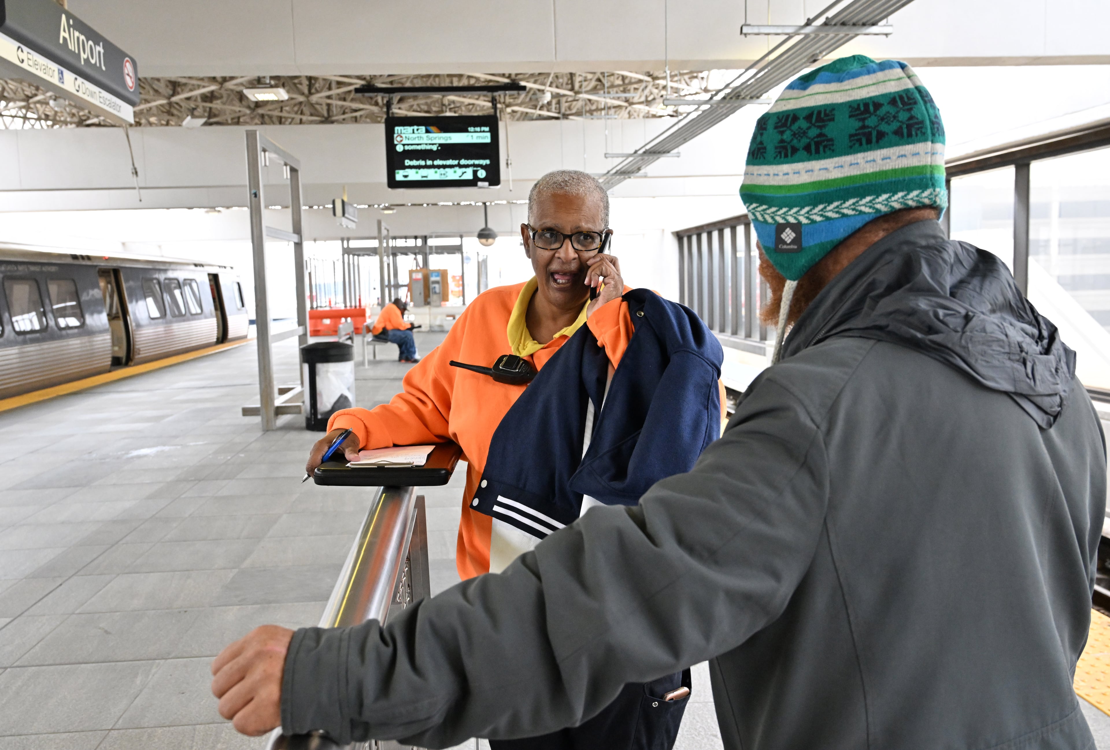 Gloria Woodard (foreground) and Vinson Allen (background), both MARTA HOPE case managers, engage with clients who need assistance at Airport station on Tuesday, March 3, 2026 (Hyosub Shin/AJC)