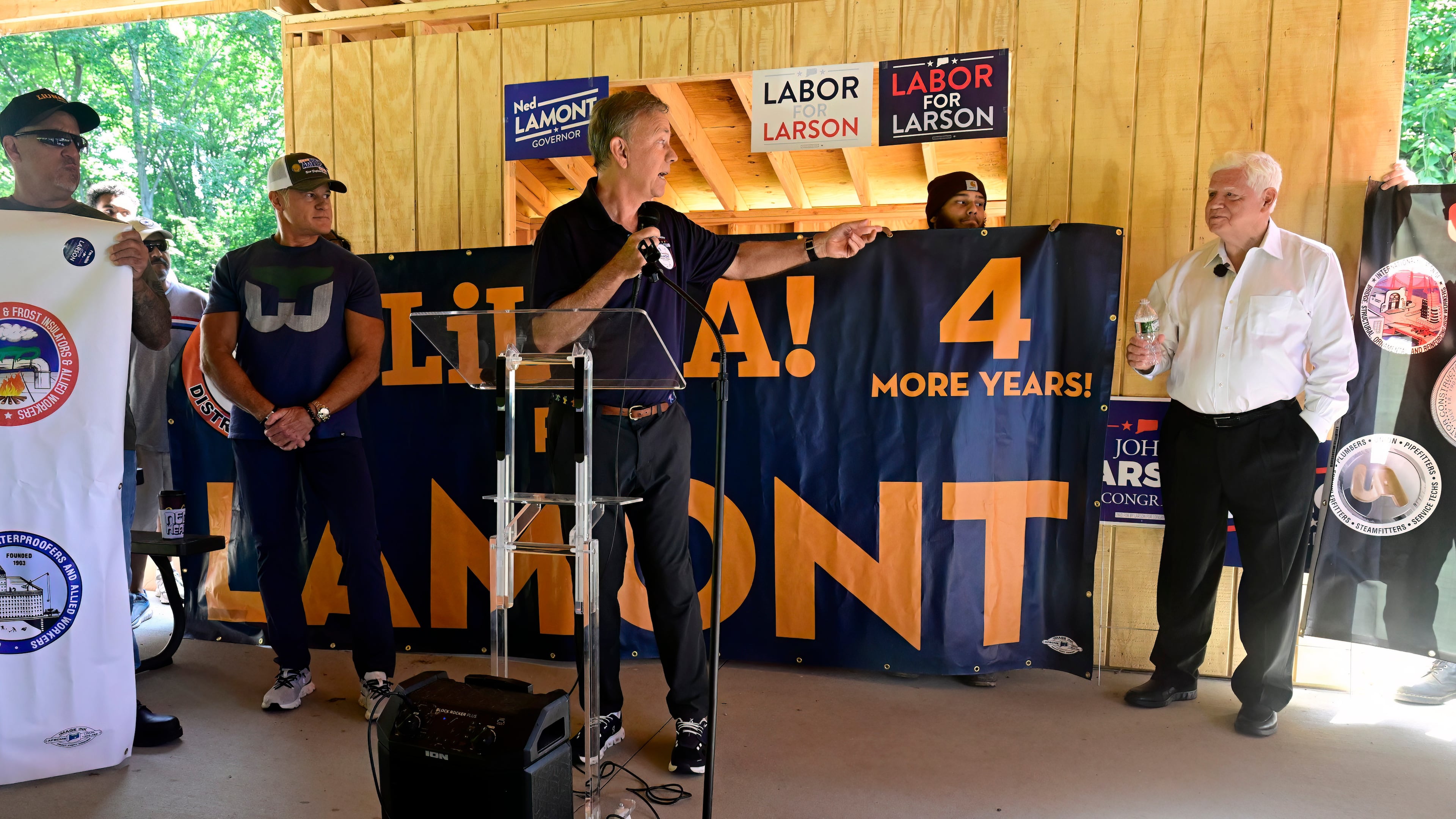 Connecticut Gov. Ned Lamont, center, gestures toward U.S. Rep. John Larson, D-Conn., during a campaign event, Saturday, July 25, 2026, in Bristol, Conn. (AP Photo/Jessica Hill)