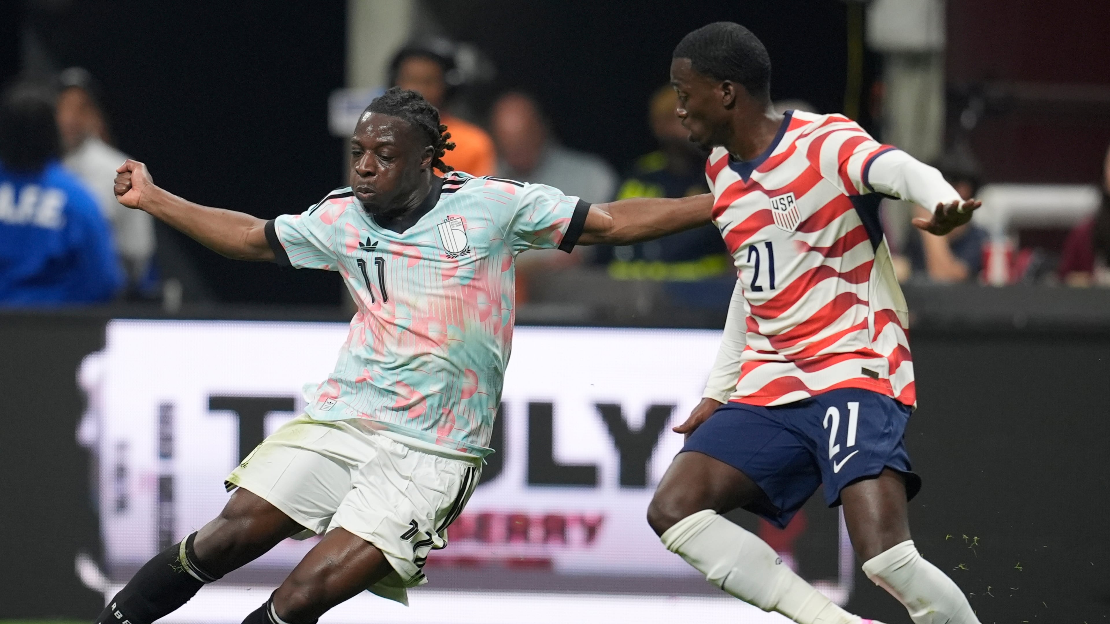 Belgium's Jeremy Doku moves against the United States' Timothy Weah (21) during an international friendly soccer match, Saturday, March 28, 2026, in Atlanta. (AP Photo/Mike Stewart)