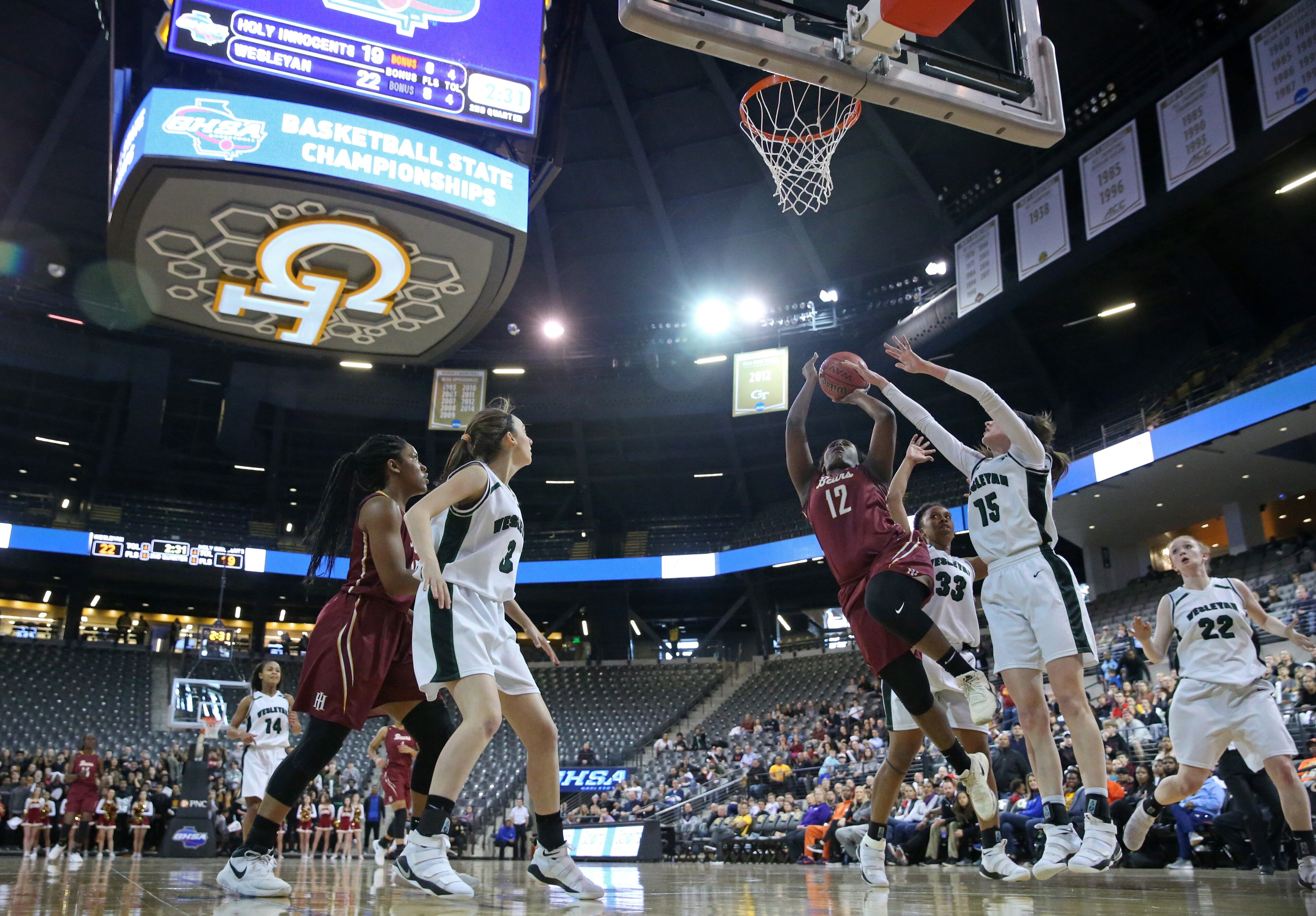 March 9, 2018 - Atlanta, Ga: Holy Innocents guard Kaila Hubbard (12) attempts a shot against Wesleyan forward Sutton West (15) during the first half of the GHSA Class A Private Girls State Championship at McCamish Pavilion Friday, March 9, 2018, in Atlanta. PHOTO / JASON GETZ