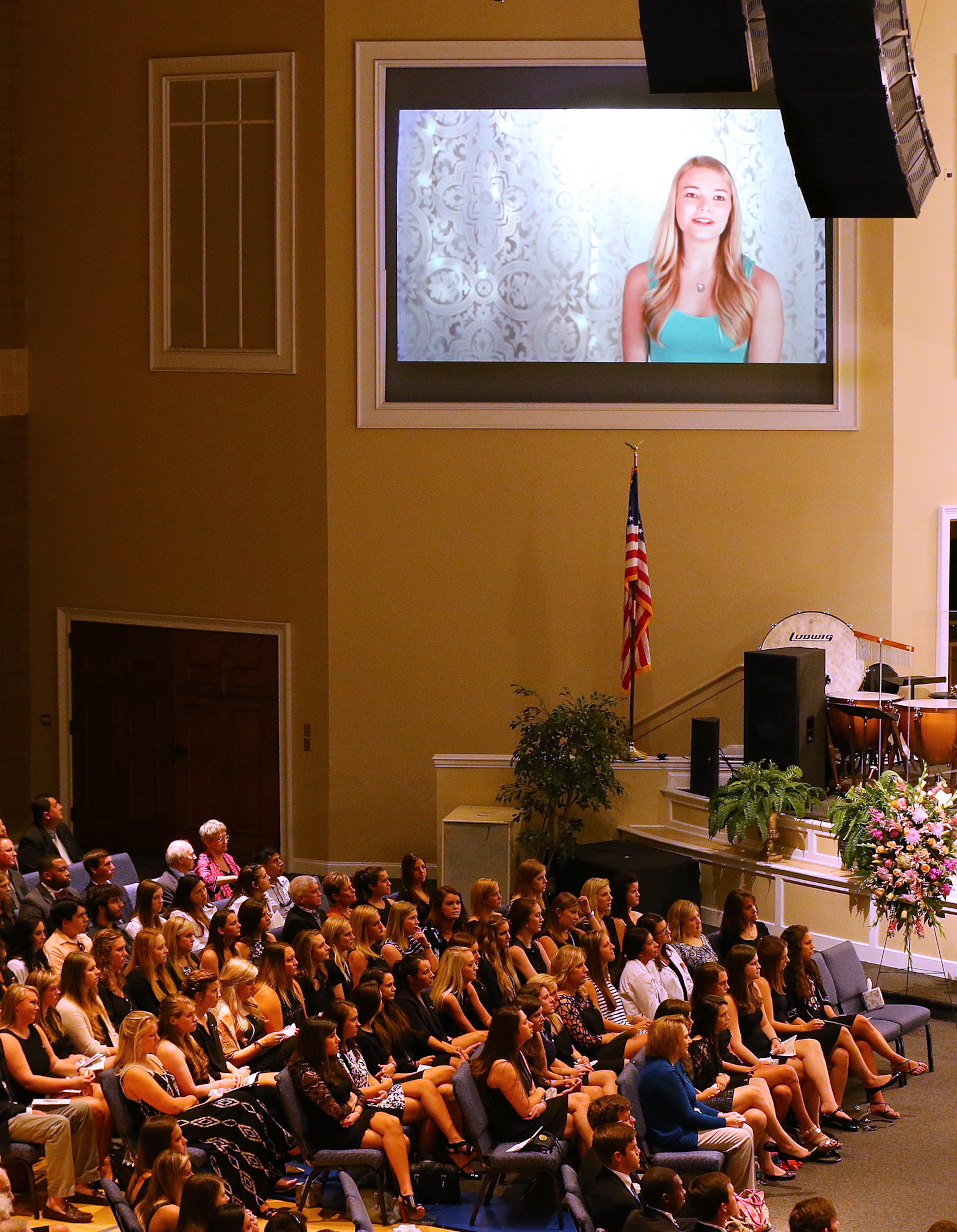 Mourners watch a tribute video during the service of praise and celebration for the life of Emily Elizabeth Clark at Burnt Hickory Baptist Church on Sunday, April 26, 2015, in Powder Springs. Clark and four other nursing students from Georgia Southern University were killed in a multi-vehicle accident while fulfilling course work in their nursing program last week. Curtis Compton / ccompton@ajc.com