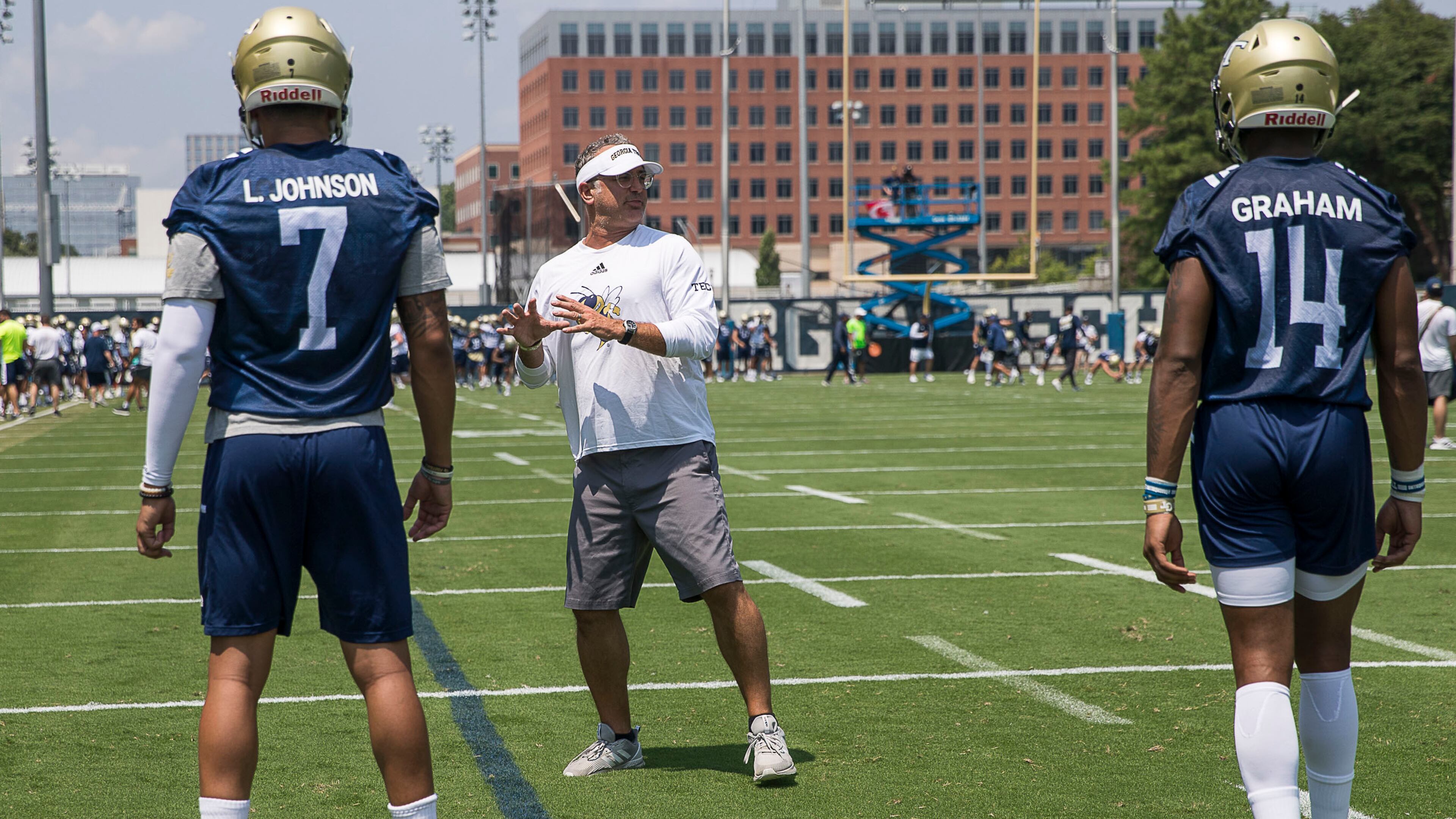 Georgia Tech offensive coordinator Dave Patenaude (center) interacts with players. (Alyssa Pointer/alyssa.pointer@ajc.com)