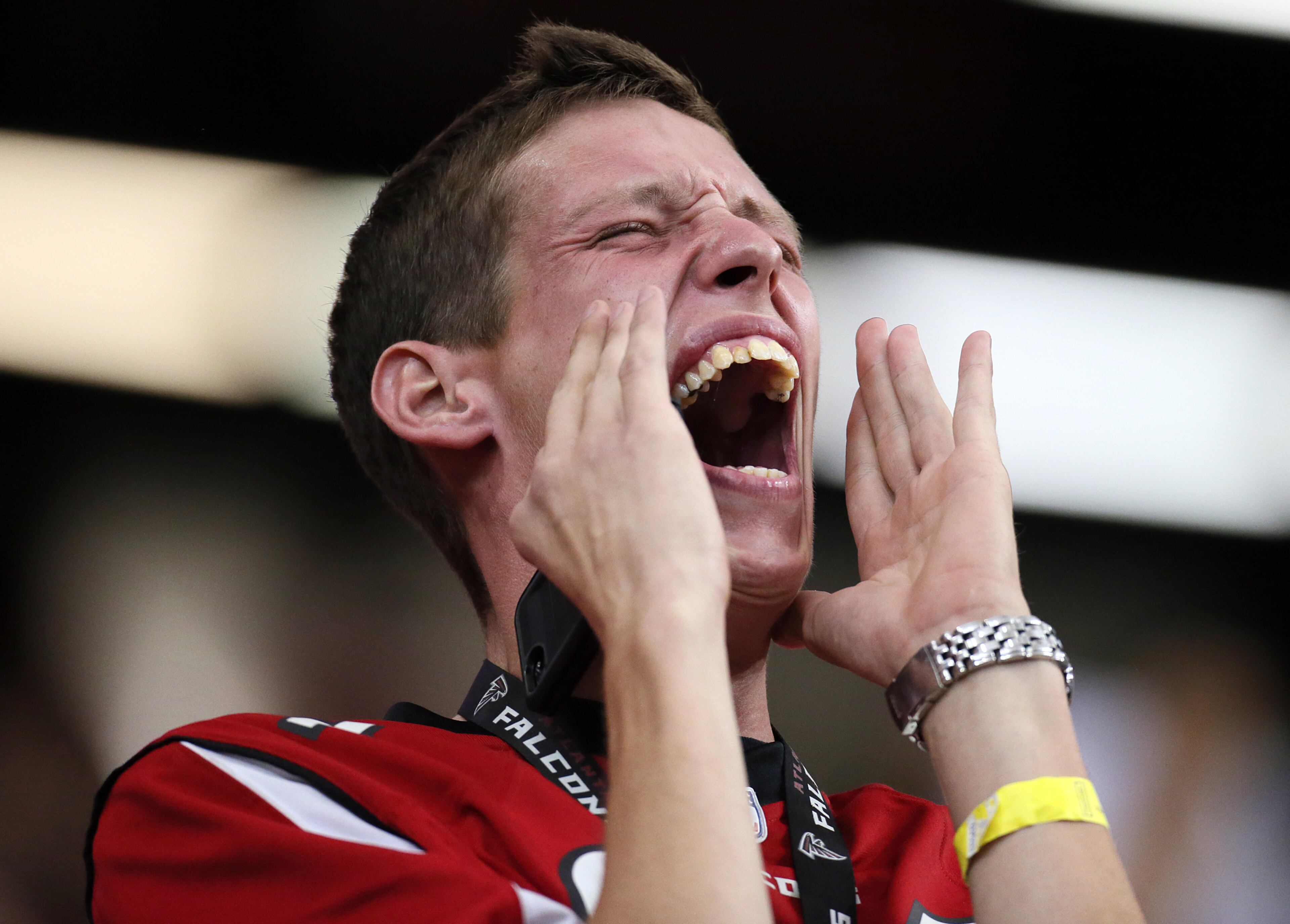 A Falcons fan makes some noise to disrupt the Rams during a third down play in the second half on Sunday, Sept. 15, 2013, in Atlanta.