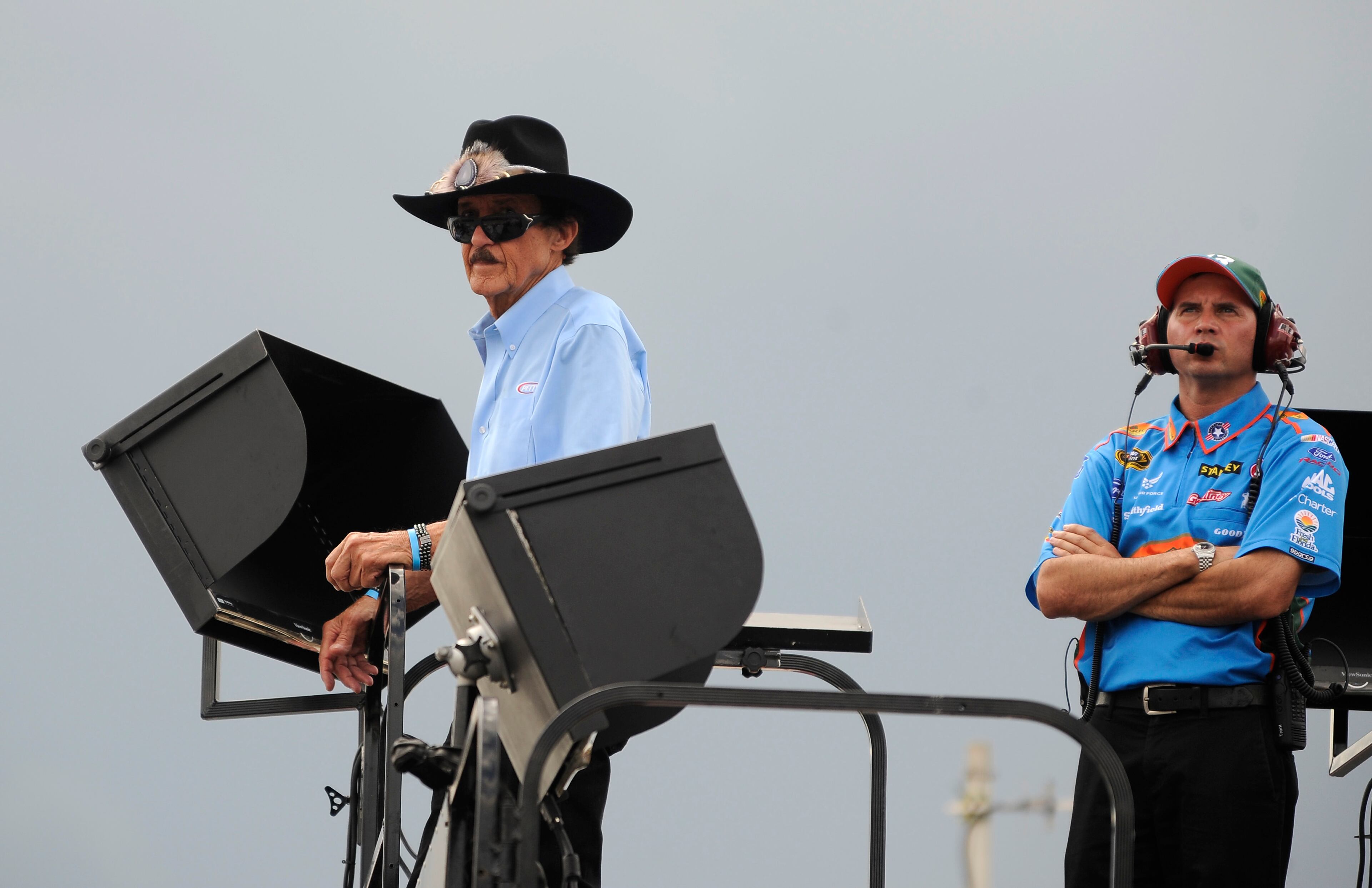 Former driver Richard Petty, lefty, the winner of 200 races, watches practice for Sunday's NASCAR Sprint Cup Series auto race at Atlanta Motor Speedway, Saturday, Aug. 30, 2014 in Hampton, Ga. (AP Photo/David Tulis)