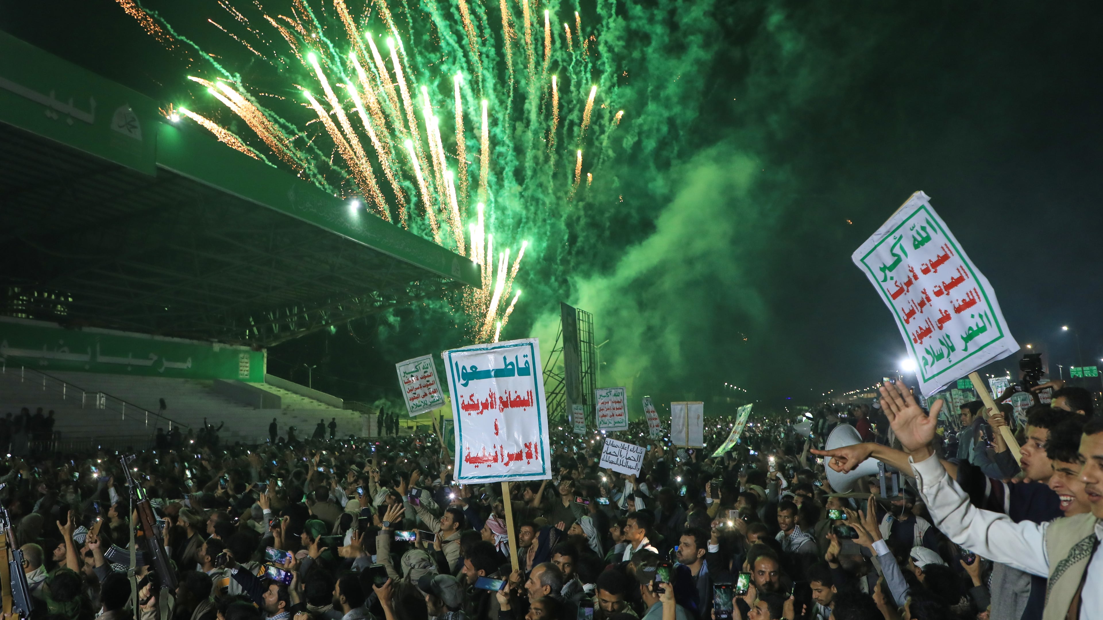 Fireworks burst as Houthi supporters rally against the Saudi-led coalition in Sanaa, Yemen, Monday, July 20, 2026. Placards in Arabic read: "God is great, Death to America, Death to Israel, A curse on the Jews and Victory to Islam" and "boycott American and Israeli goods". (AP Photo/Osamah Abdulrahman)