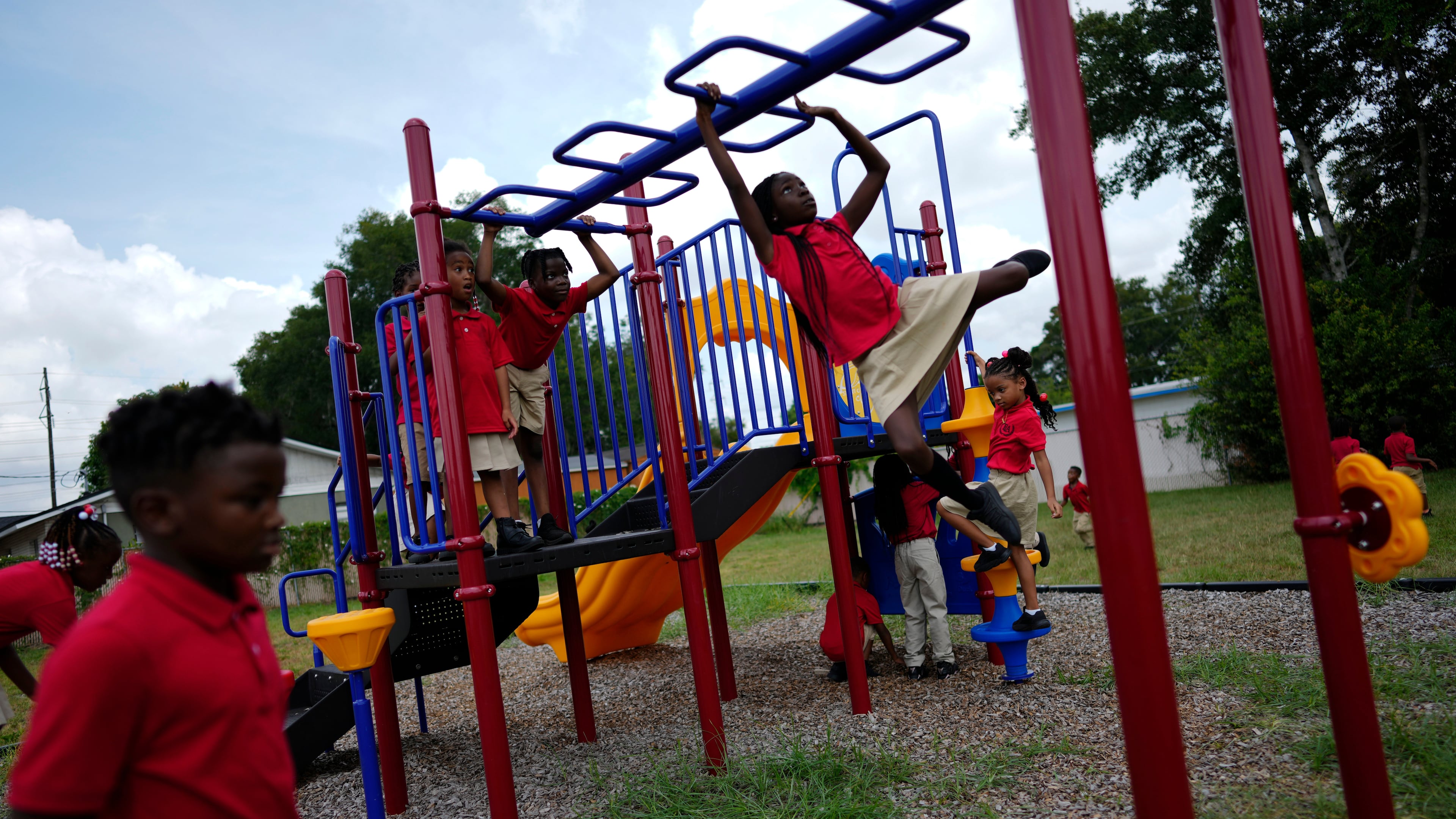 FILE - Students from Thomas Leadership Academy play on the school's playground in Eatonville, Fla., on Aug. 23, 2023. (AP Photo/Rebecca Blackwell, File)