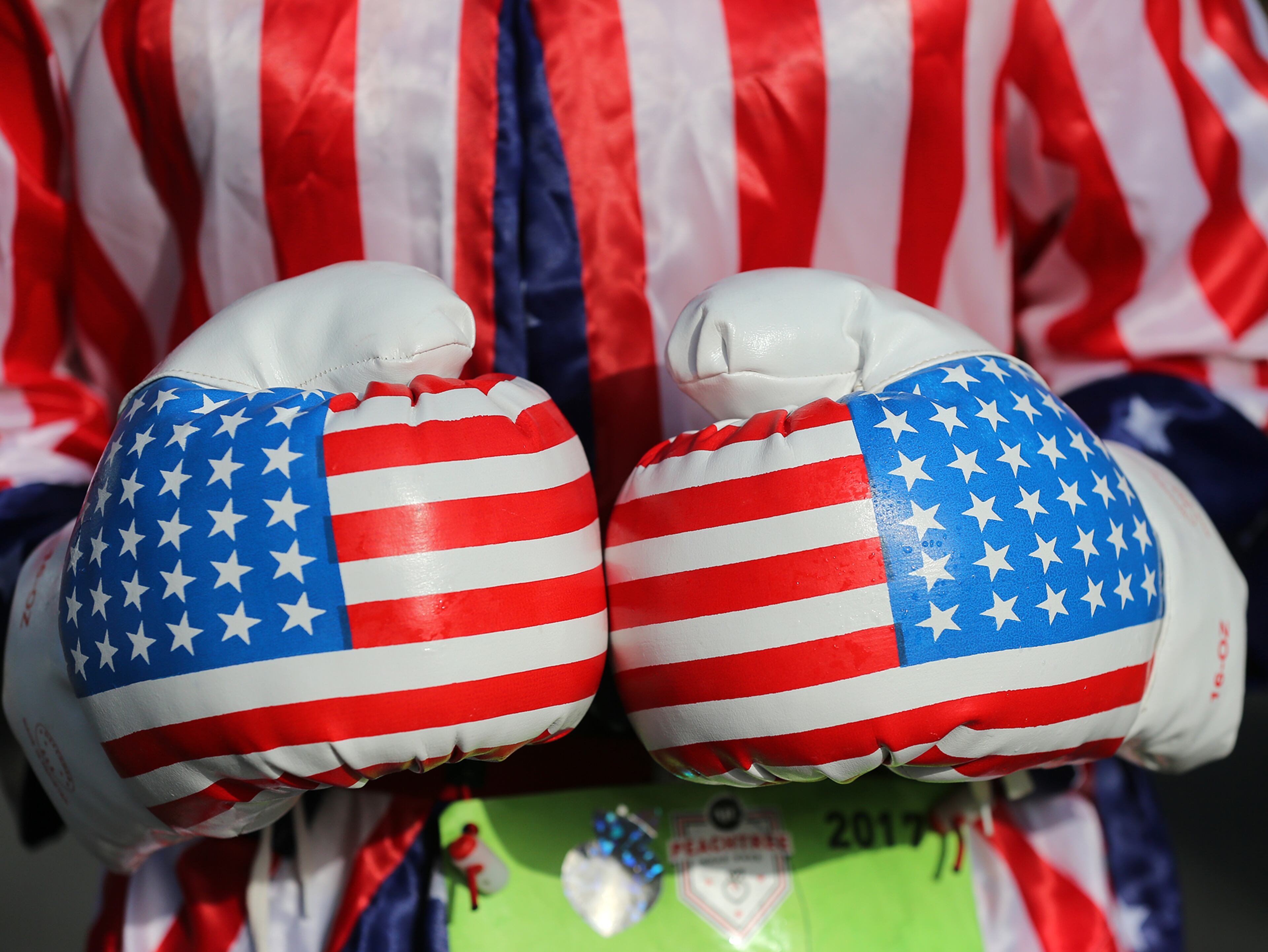 July 04, 2017 Atlanta: William Brian Hallam, Atlanta, sports patriotic boxing gloves as part of his holiday attire while running in the 48th AJC Peachtree Road Race on Tuesday, July 4, 2017, in Atlanta. Curtis Compton/ccompton@ajc.com