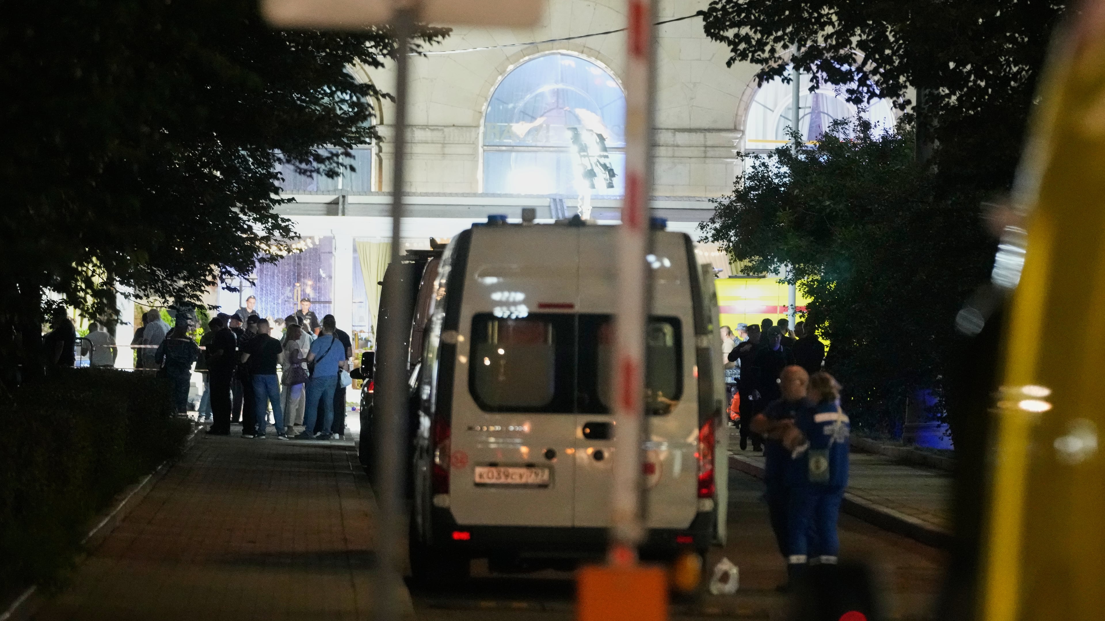 Ambulances and special services vehicles are parked near the site where an improvised explosive device detonated at a restaurant in central Moscow, Saturday, Aug. 1, 2026. (AP Photo/Pavel Bednyakov)