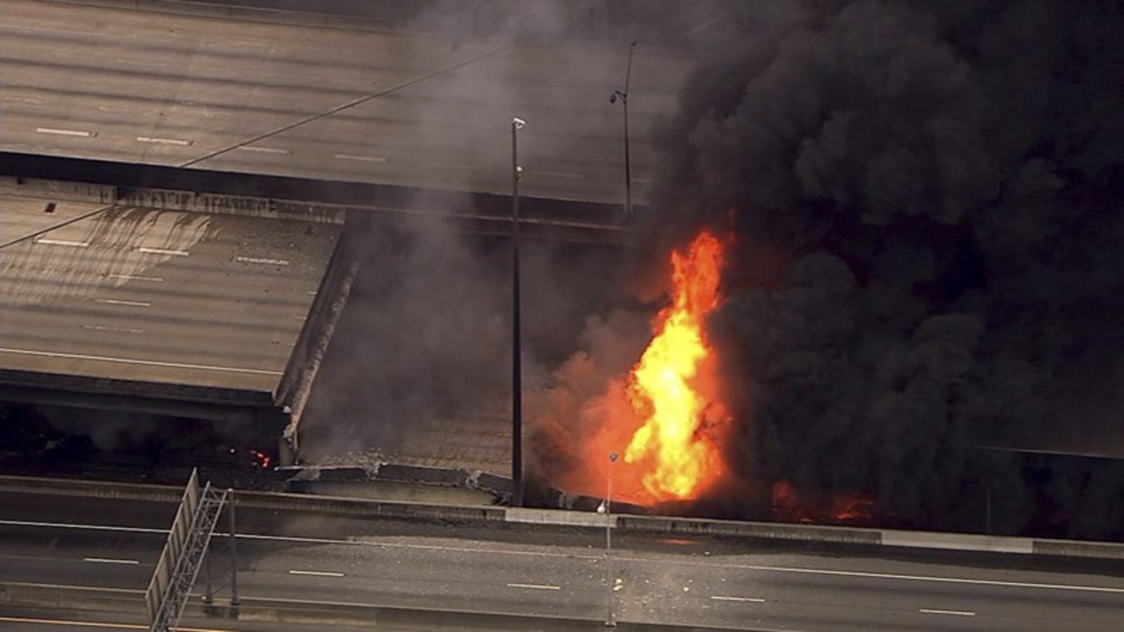 In this aerial image from a video shot by Atlanta TV station WSB-TV, a large fire that caused an overpass on Interstate 85 to collapse burns on March 30, 2017.