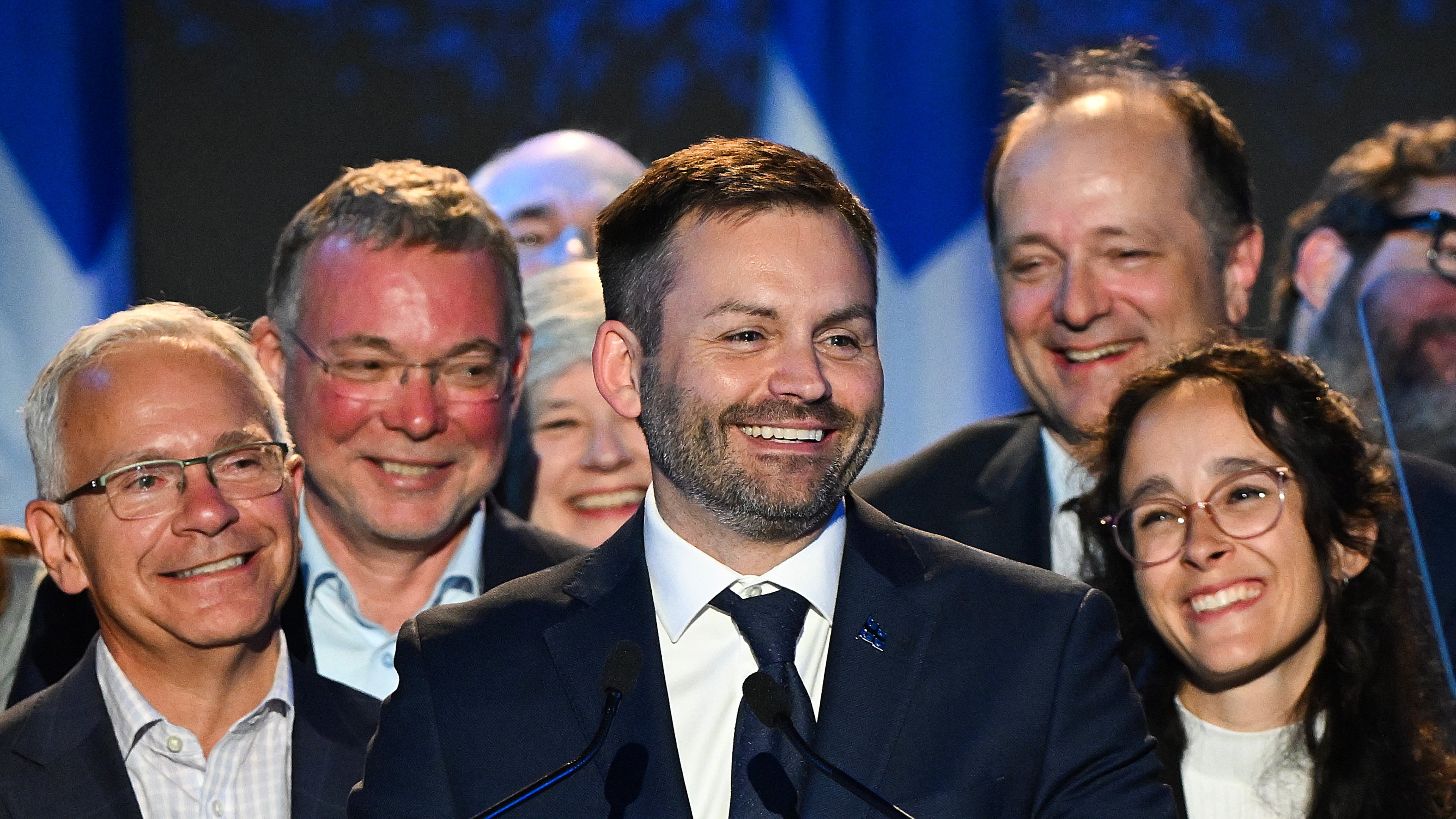 Parti Quebecois Leader Paul St-Pierre Plamondon, center, speaks to supporters after winning the provincial election in Montreal, Quebec on Monday, Oct. 5, 2026. (Graham Hughes/The Canadian Press via AP)