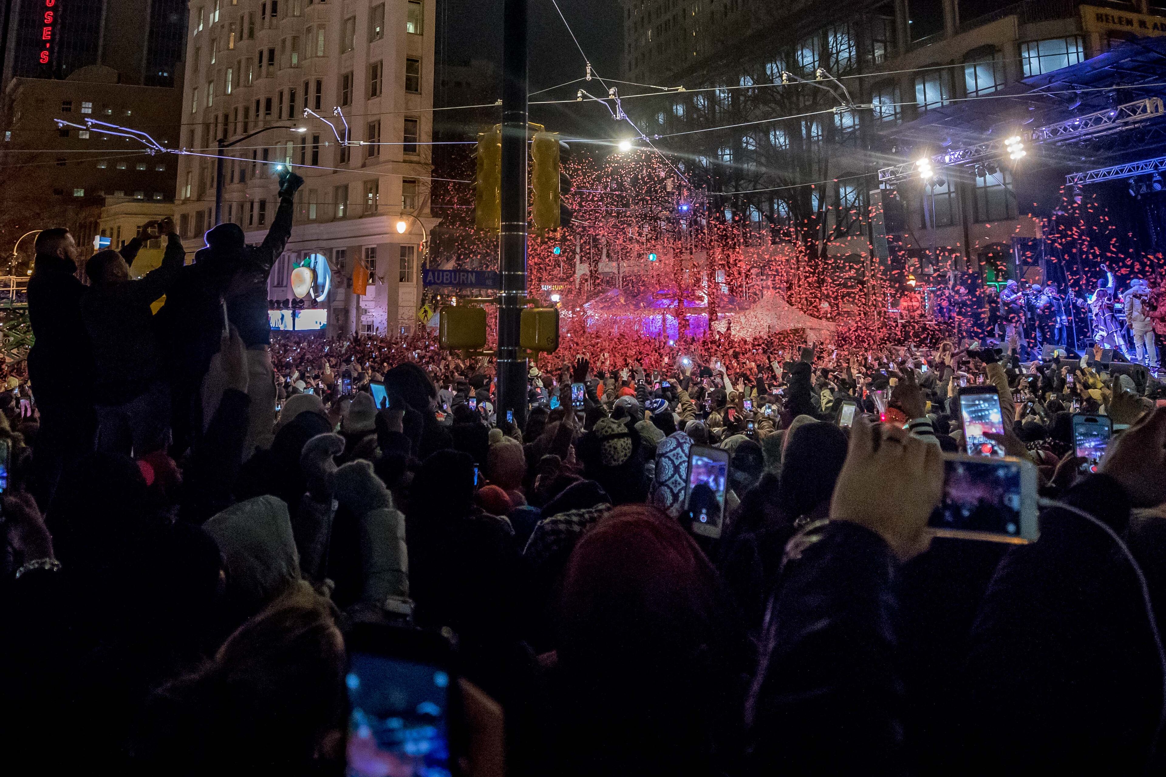 People celebrate as 2018 arrives with the Peach Drop 2017 at Wooddruff Park, Jan. 1, 2018, in Atlanta. BRANDEN CAMP/SPECIAL