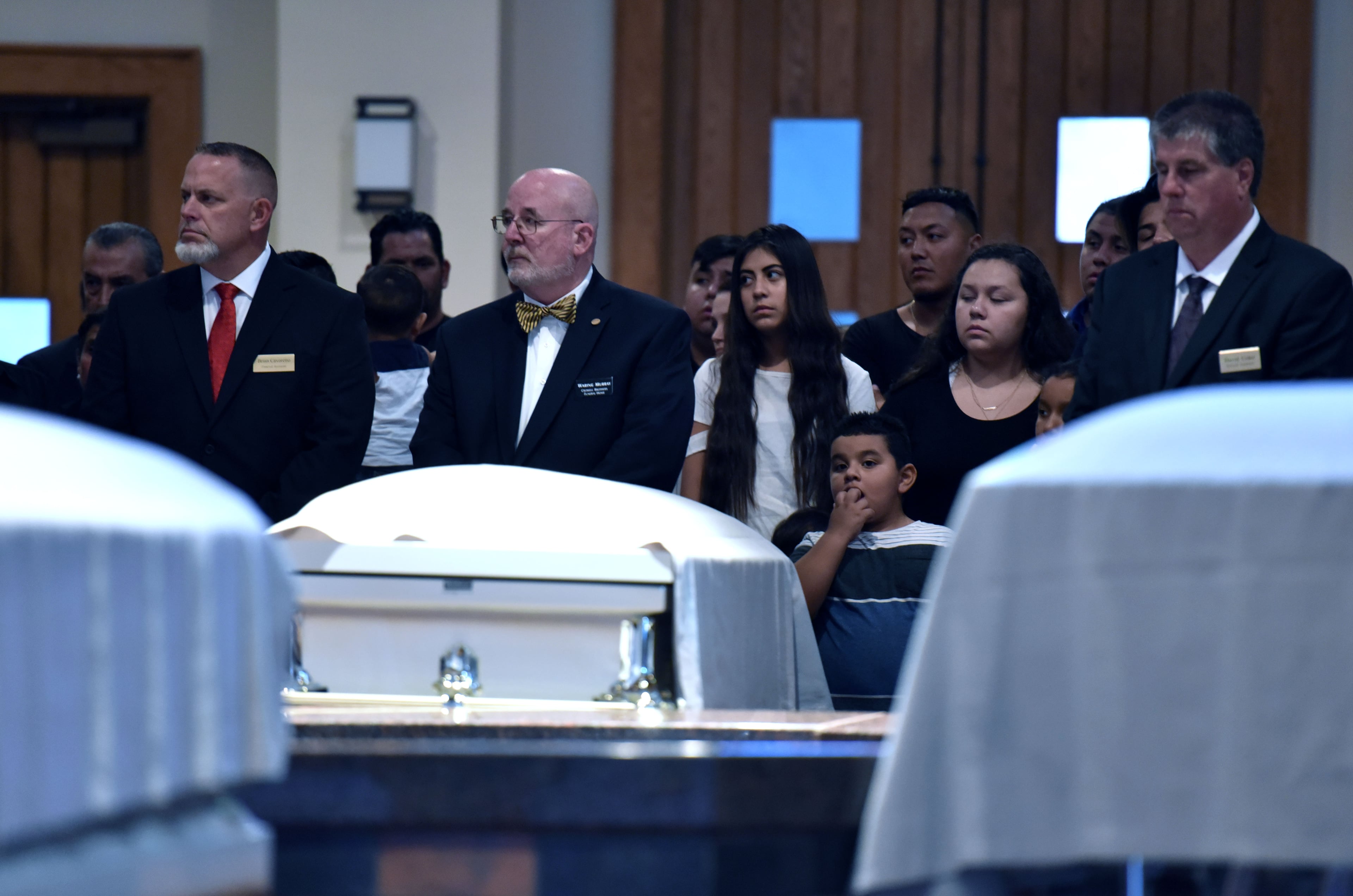July 13, 2017 Lawrenceville - Fives caskets of the victims - Martin Romero, 33, and four of his children -are surrounded by mourners before the funeral mass for at St. Lawrence Catholic Church in Lawrenceville on Thursday, July 13, 2017. Thirty-three-year-old Martin Romero and children Axel, 1, Dillan, 4, Dacota, 6 and Isabela Martinez, 10, were stabbed to death last week in their Loganville home. Nine-year-old daughter Diana Romero survived the attack and is recovering from her wounds at Children's Healthcare of Atlanta. HYOSUB SHIN / HSHIN@AJC.COM
