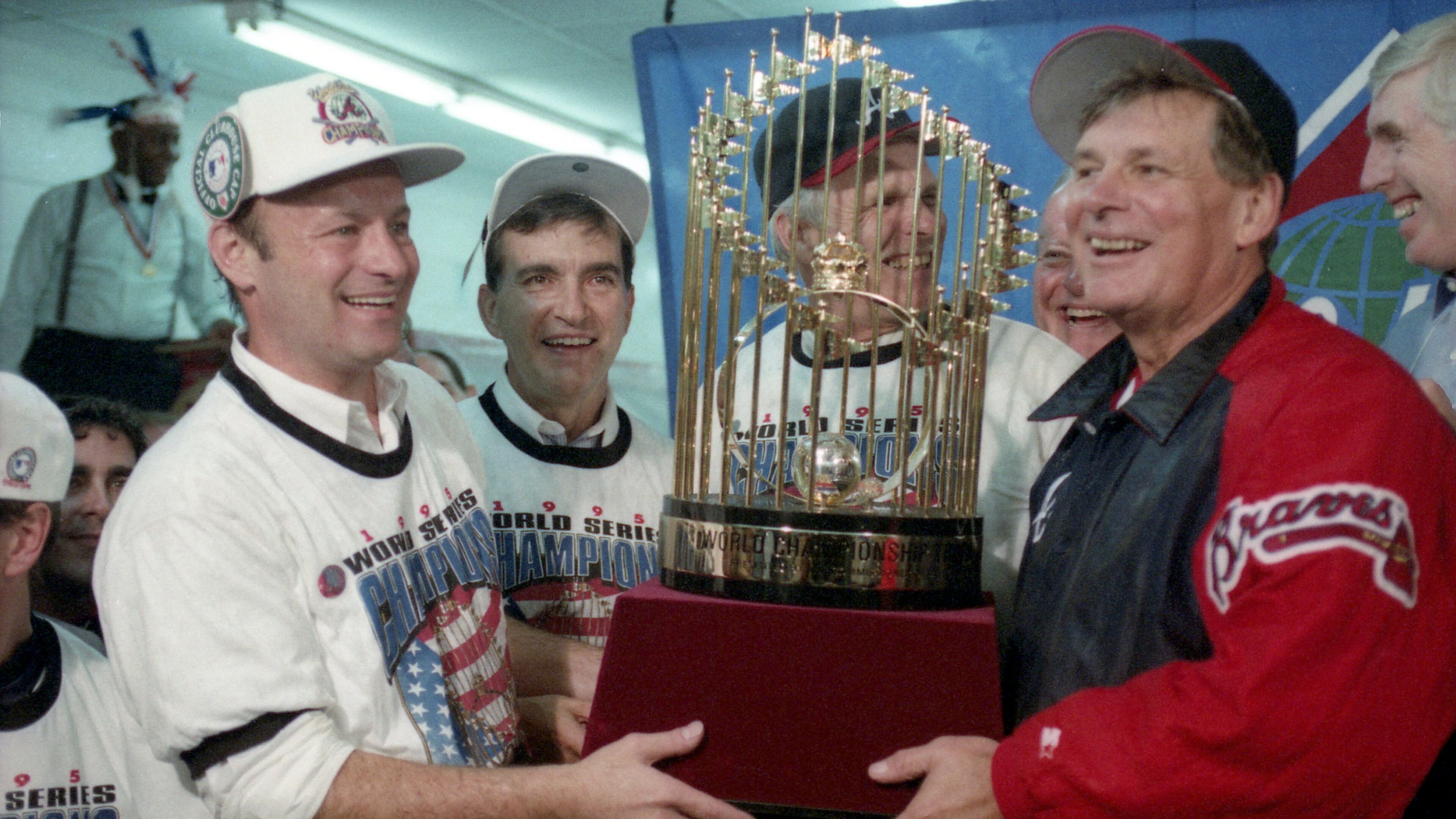 We are the champions!! Braves manager Bobby Cox (right) holds the championship trophy along with (from left) Stan Kasten, John Schuerholz and owner Ted Turner after winning the 1995 World Series. The Braves defeated the Cleveland Indians 1-0 in Game 6 on Oct. 28, 1995 to win the best-of-seven series four games to two. (From the files of the Atlanta Journal-Constitution)