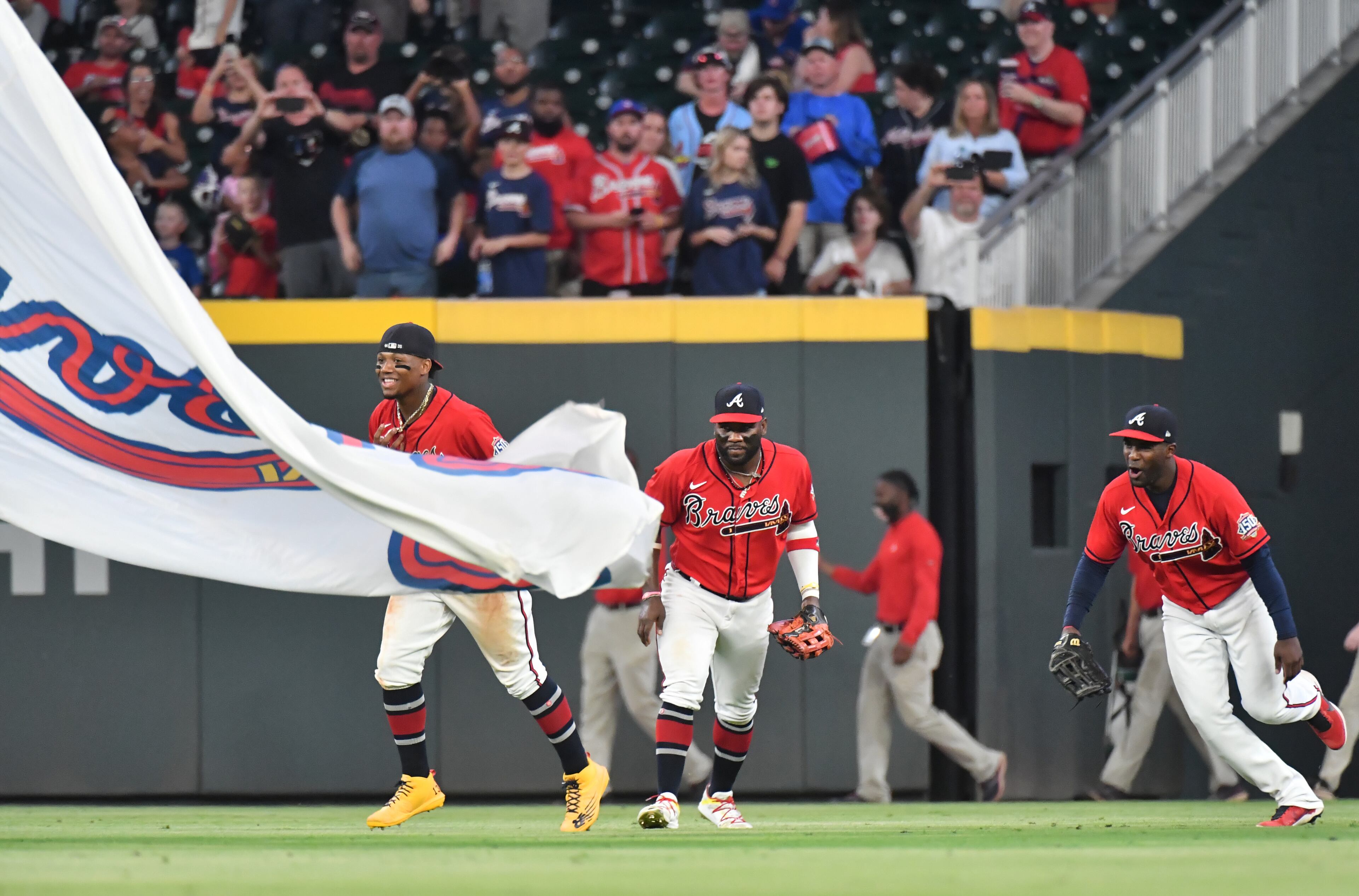 Braves outfielders (from left) Ronald Acuna Jr., Abraham Almonte and Guillermo Heredia celebrate their 9-1 victory over St. Louis Cardinals at Truist Park. (Hyosub Shin / Hyosub.Shin@ajc.com)