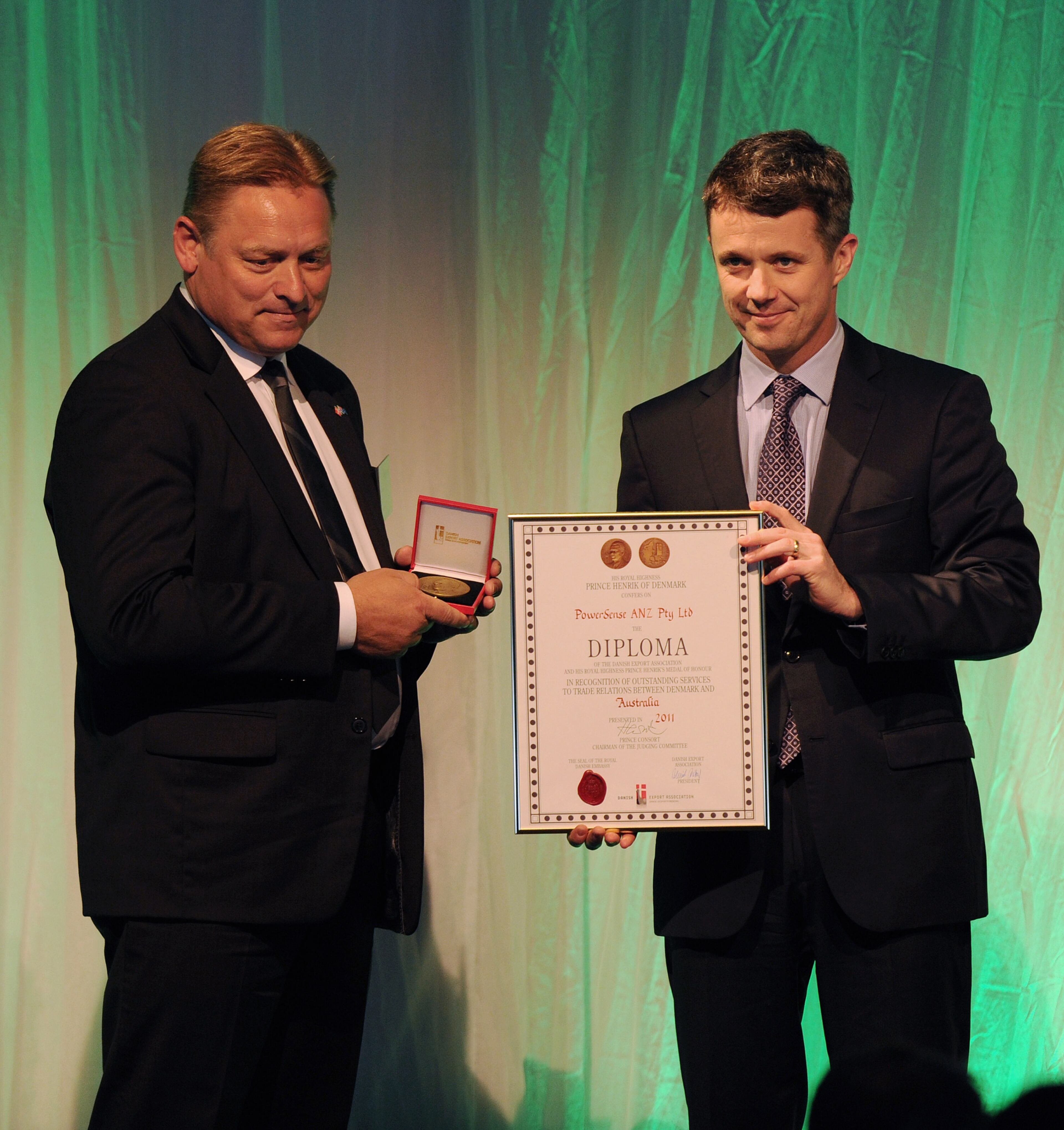 Prince Frederik of Denmark (R) presents the Danish export association's honorary diploma and H.R.H. Prince Henrik's medal of honour to PowerSense CEO Brian Sorensen (L), during a business delegation lunch at the Hotel Sofitel Wentworth on November 21, 2011 in Sydney, Australia. (Photo by Greg Wood - Pool/Getty Images)