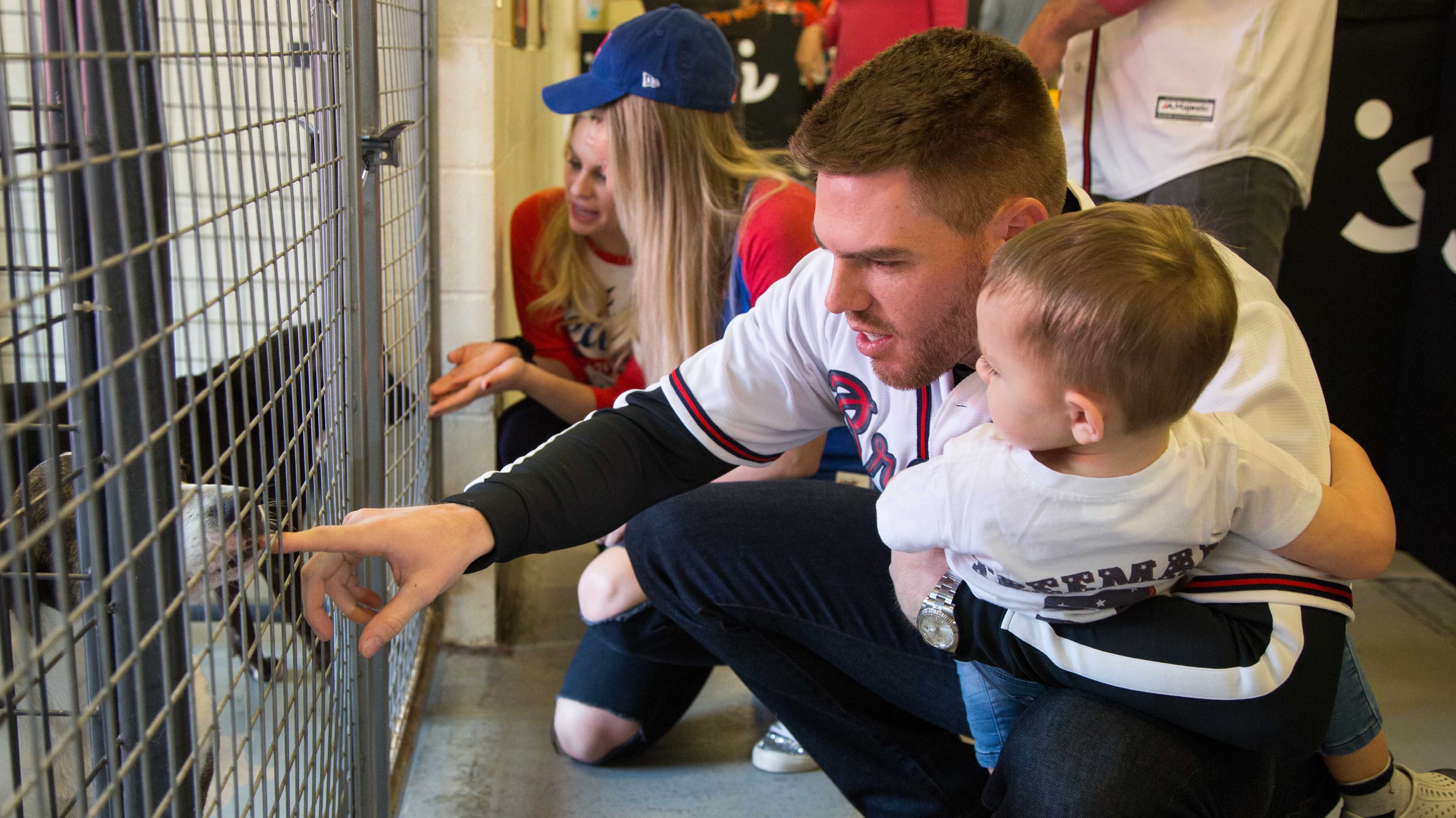 Atlanta Braves baseball player Freddie Freeman held his son Charlie (age 2) as they met dogs during a visit to Best Friends in Atlanta as part of the team's Season of Giving on Wednesday, Dec. 12th, 2018. The animal shelter works collaboratively with area shelters, animal welfare organizations and individuals to save the lives of pets in shelters. (Photo by Phil Skinner)