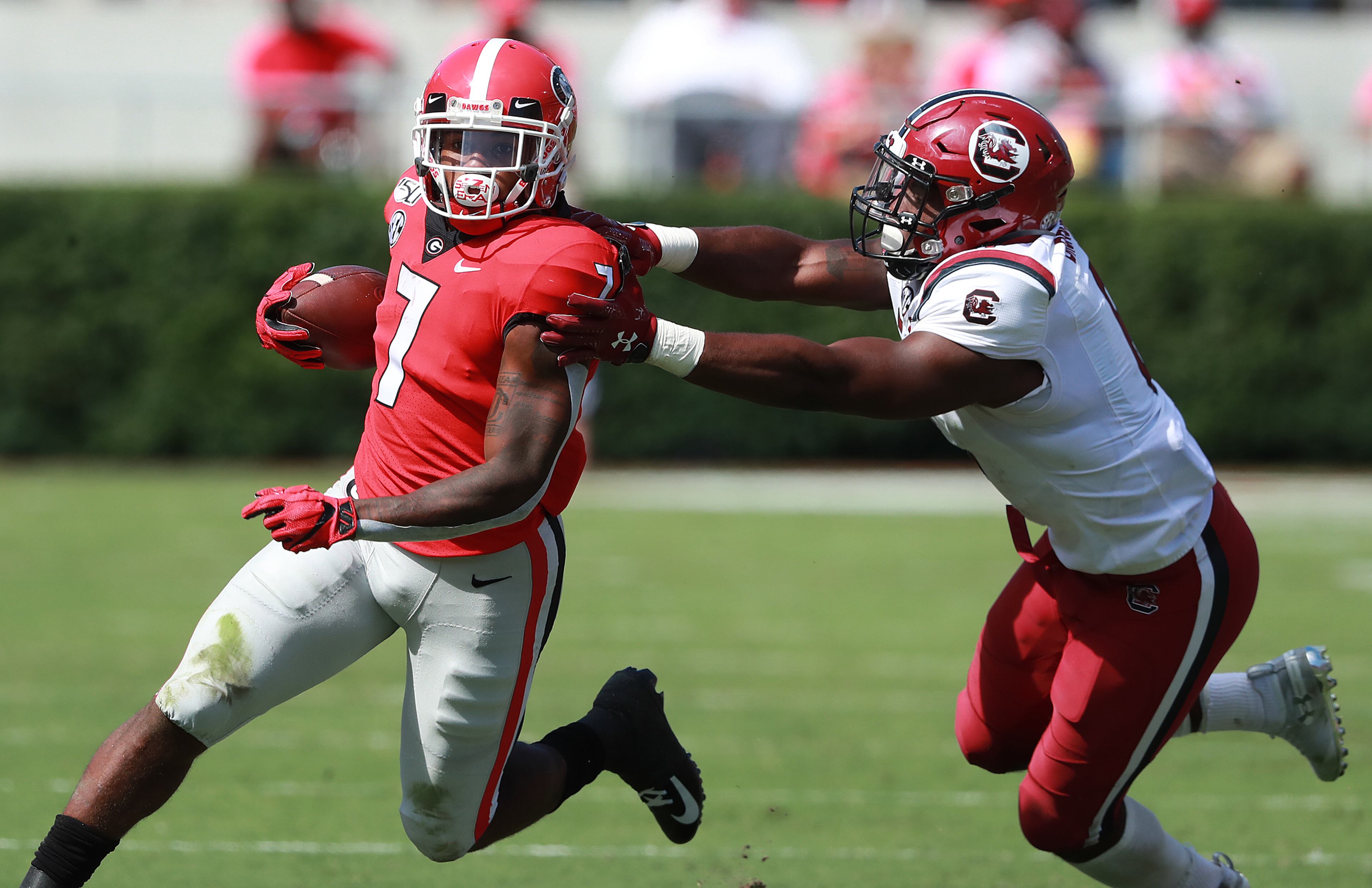 Georgia tailback D'Andre Swift runs for yardage against South Carolina linebacker T.J. Brunson. Curtis Compton/ccompton@ajc.com