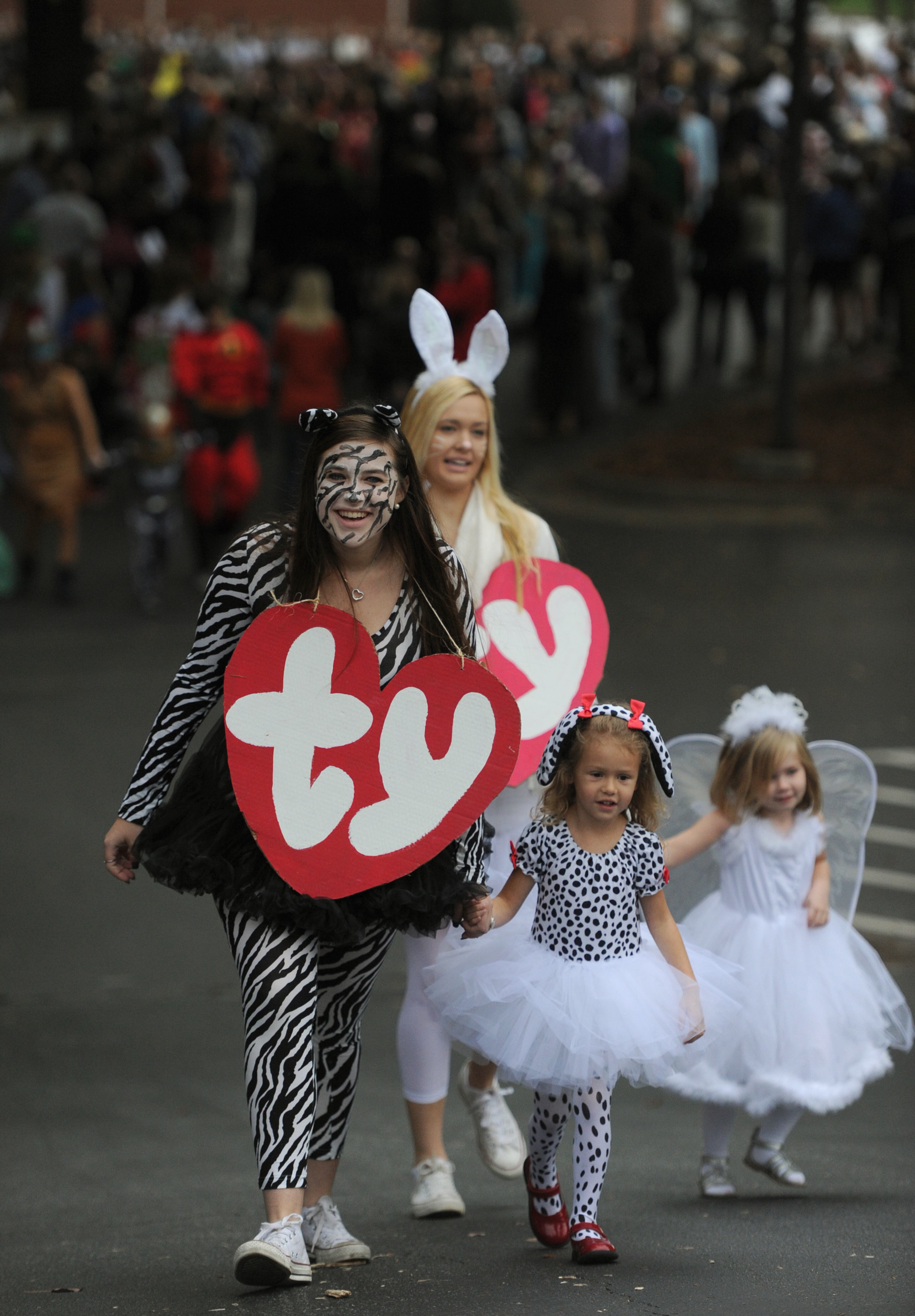 Madison Miller holds Molly Riffe's hand as Julia Wright holds Leah Stone's hand as they march in Holy Innocents' Episcopal School's annual Halloween Parade Thursday, October 31, 2013. One hundred fifteen seniors held the hands of 100 primary school kids as they marched in front of students, teachers, parents and friends. This year was the 45th year for the parade at the school founded in 1959. Principal Greg Kaiser dressed as Sesame Street's Count von Count on the day when Sesame Street was actually honoring The Coun'ts beloved puppeteer, the late Jerry Nelson who died last year. JOHNNY CRAWFORD / JCRAWFORD@AJC.COM