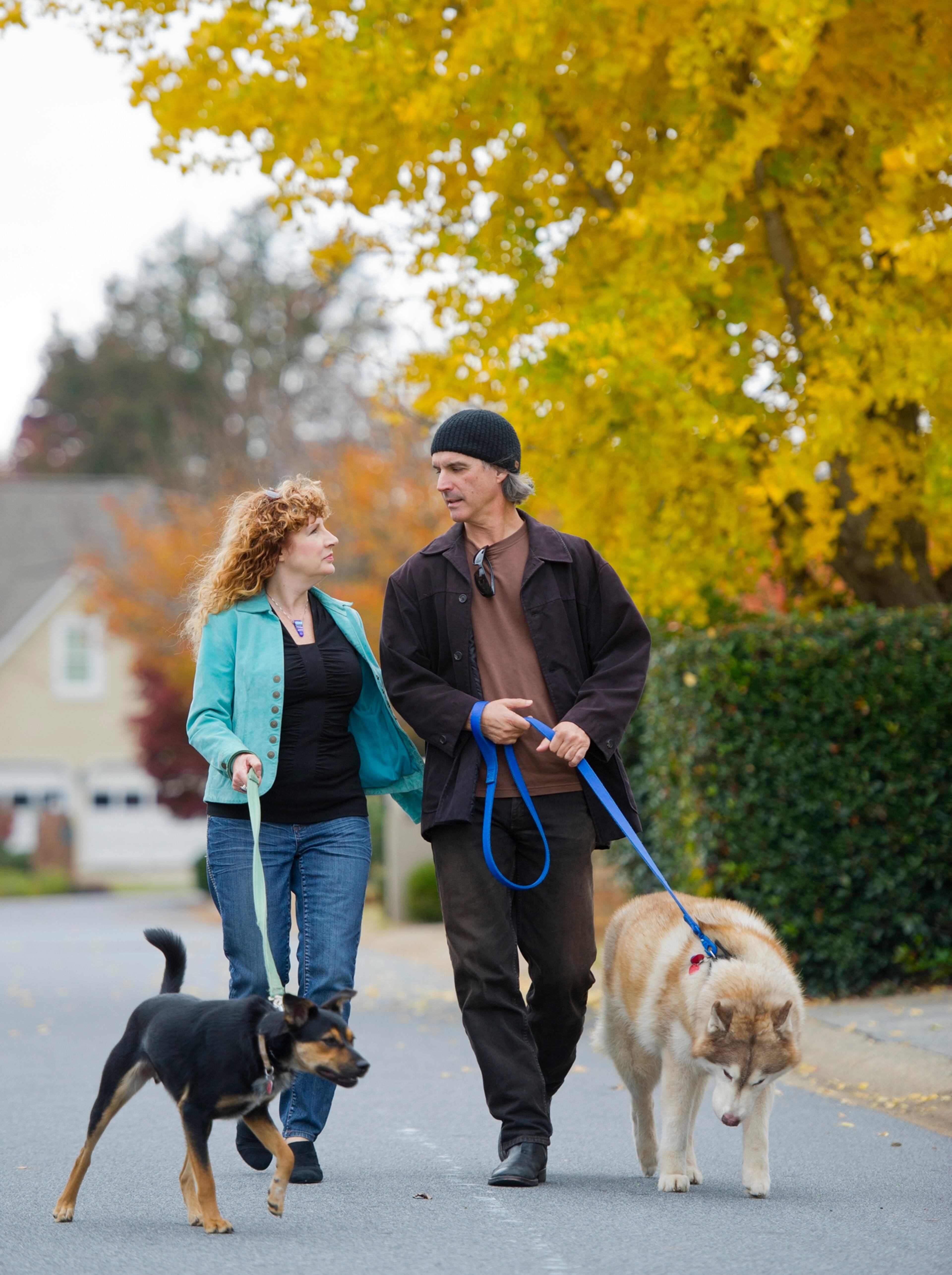 Kevin and Echo Garrett take their dogs, Marley and Berry, for a walk in their Marietta neighborhood. Kevin suffered a brain injury in an automobile accident in 2004. He has come a long way in his recovery and has returned to work as a photographer, although he struggles with short-term memory loss.