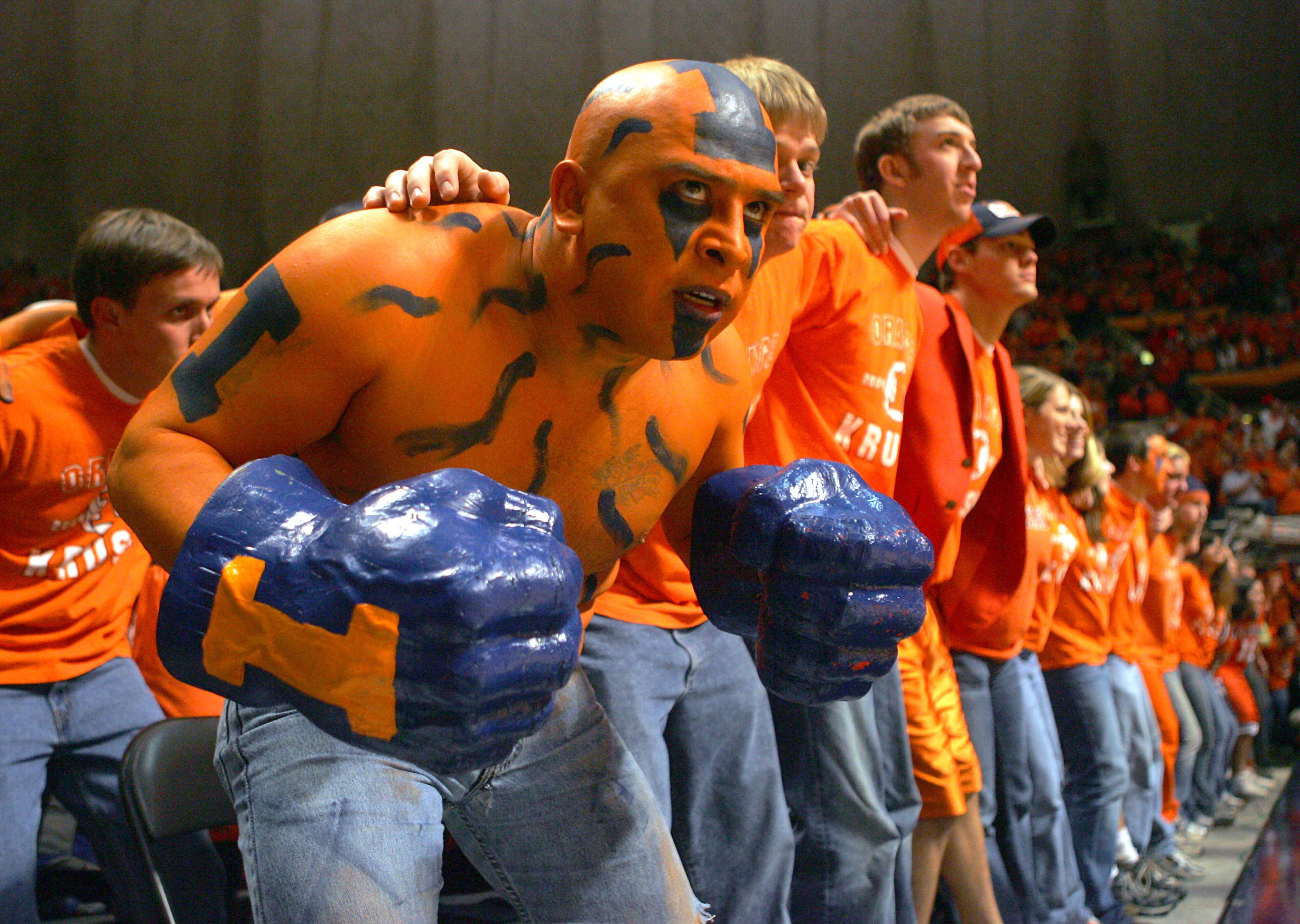 Ceasar Perez, a fan of the Illinois Fighting Illini, joins other students as they sway during player introductions before a game against the Iowa Hawkeyes on Jan. 20, 2005, in the Assembly Hall at the University of Illinois in Champaign, Ill.