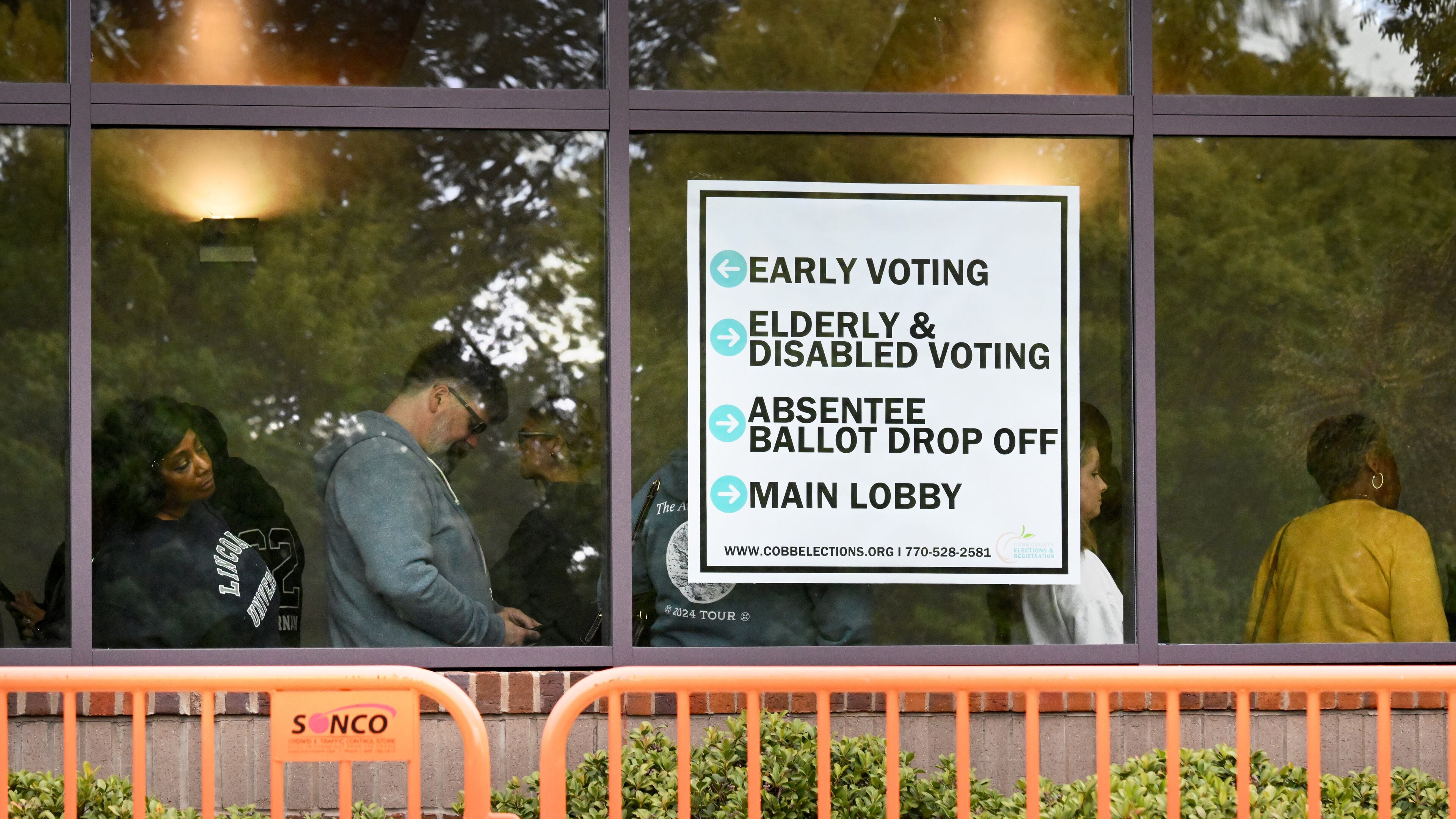 Voters line up as they arrive at for early voting at the Cobb County Elections and Registration Main Office, Tuesday, October 15, 2024, in Marietta. (Hyosub Shin / AJC)