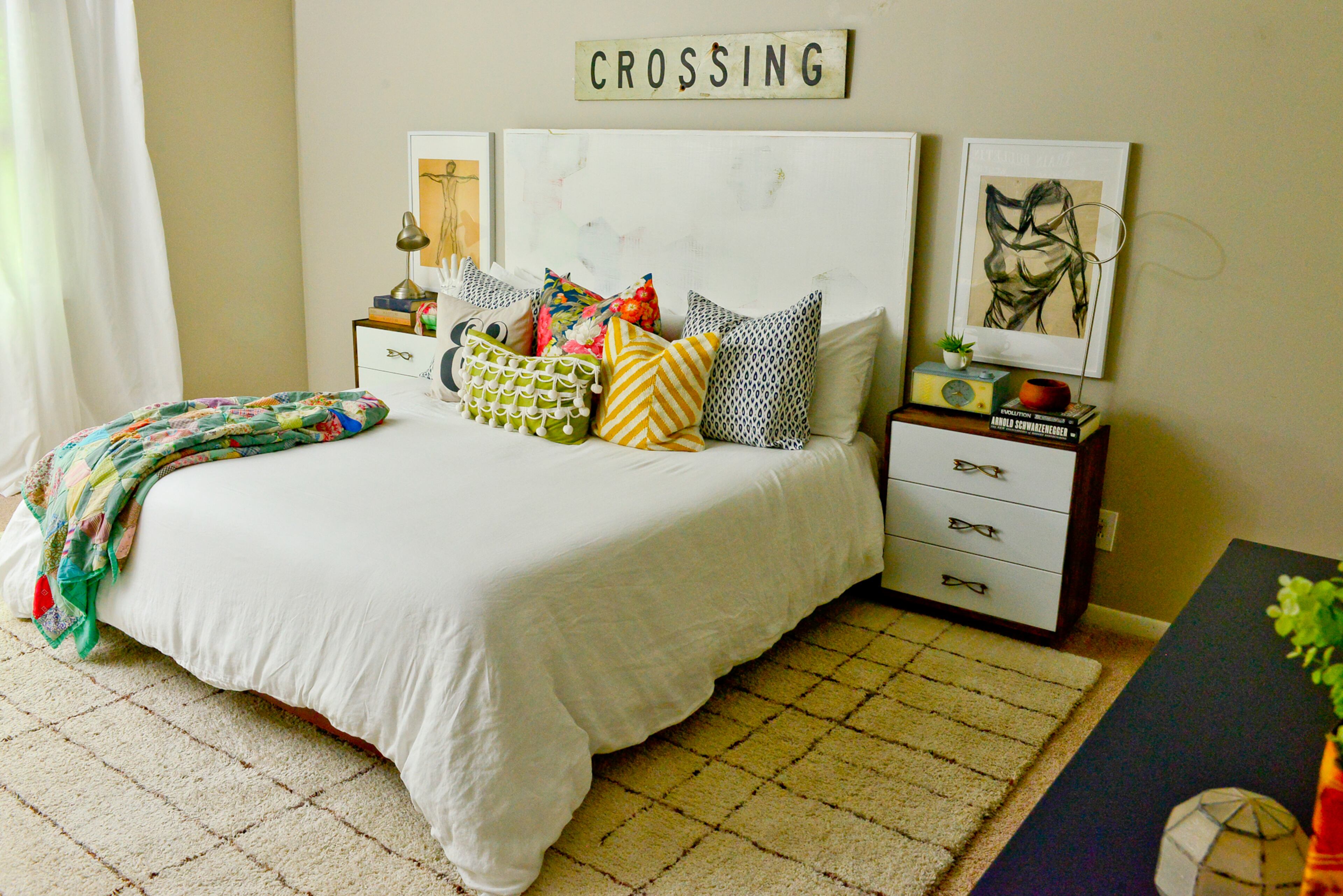 Master bedroom: Framed artwork flanking the bed are unexpected choices above the nightstands in the master bedroom. Homeowner Dena Stormer made over the Ikea nightstands to give them mid-century modern style.