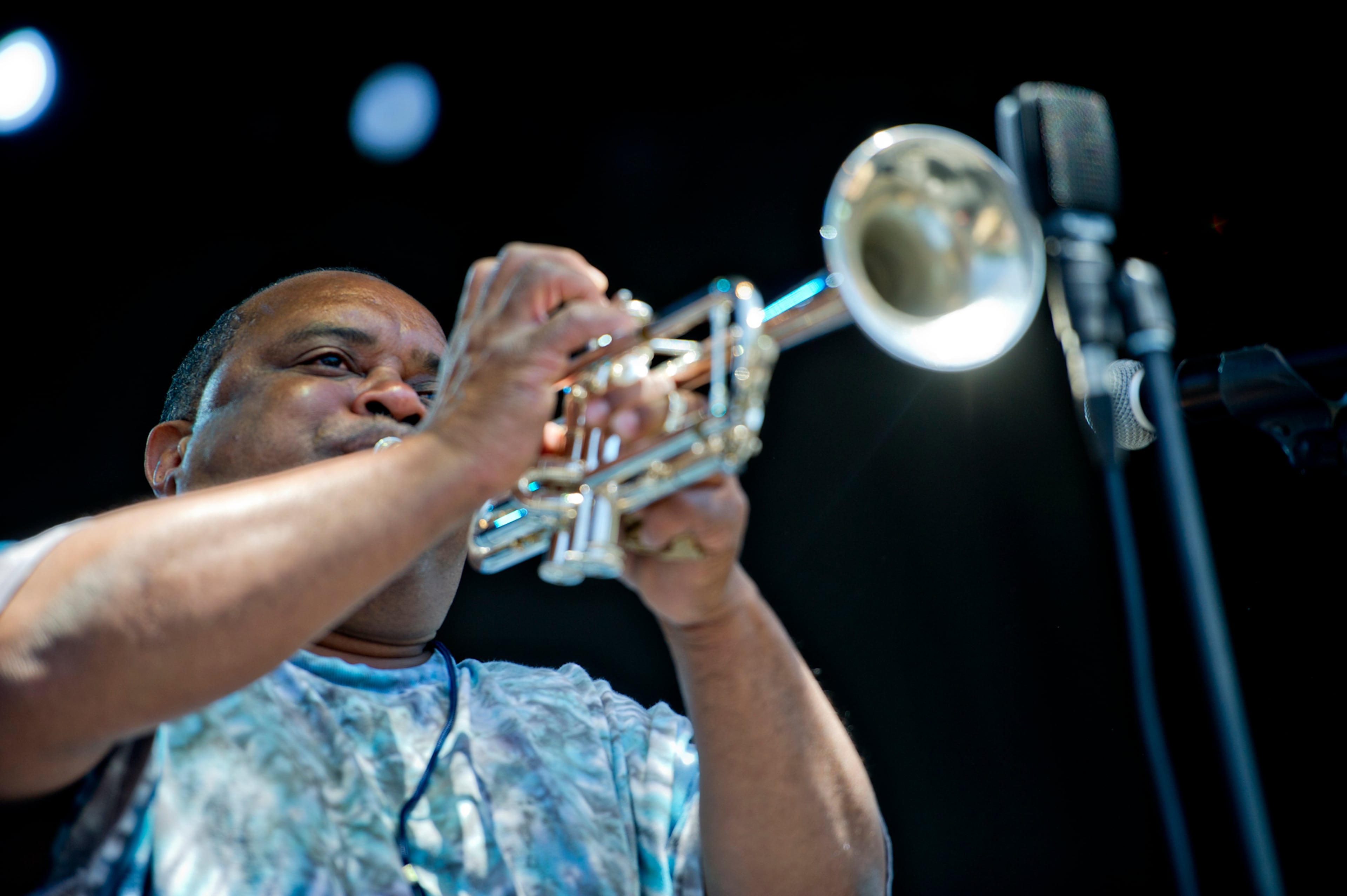 Efrem Towns plays his trumpet as he performs with other members of the Dirty Dozen Brass Band on stage during the Sweetwater 420 Festival at Centennial Olympic Park on Sunday, April 20, 2014.