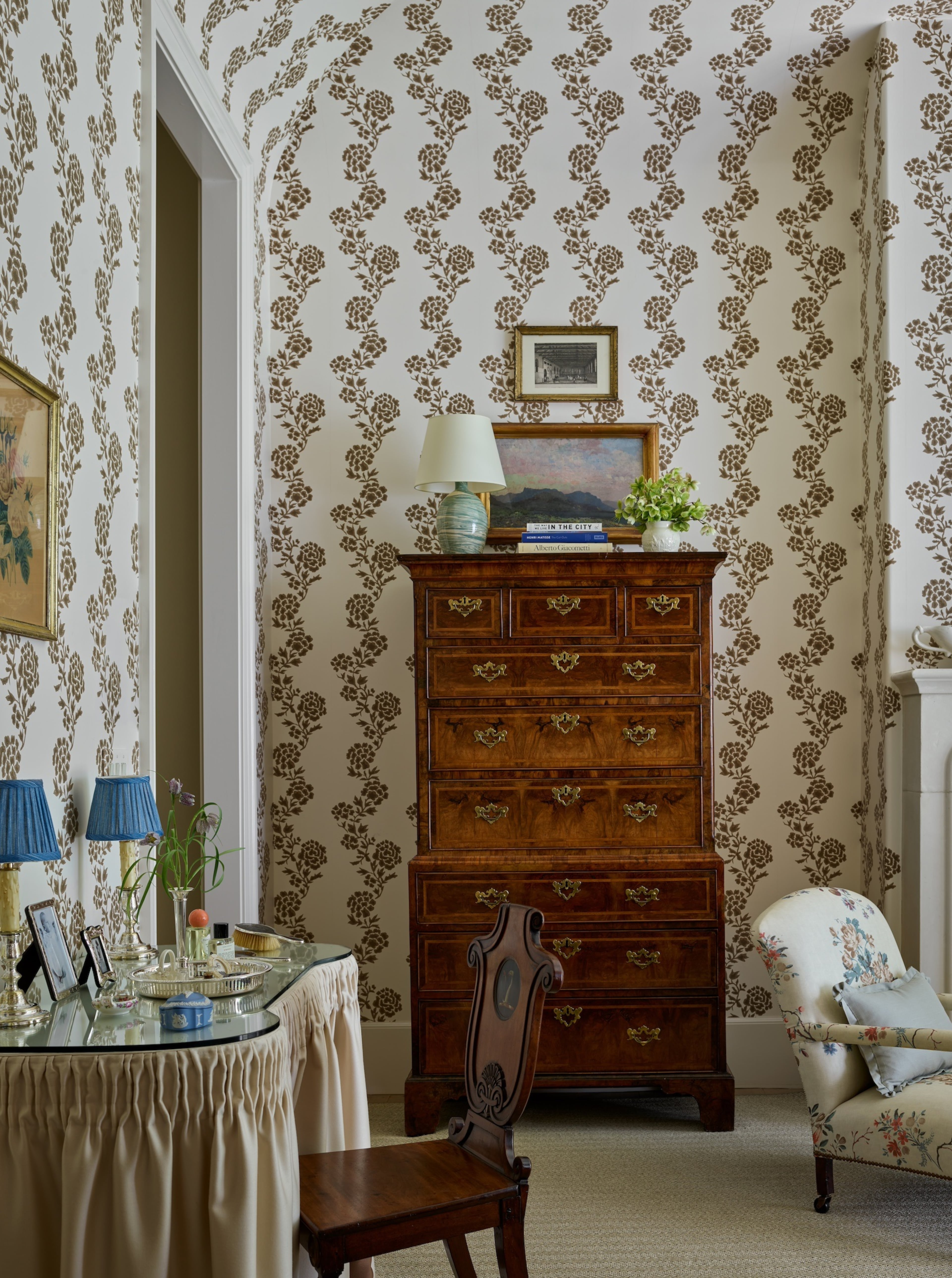 Wallpaper featuring brown flowers and an antique chest of drawers ground this bedroom from interior designer Lauren E. Lowe of Lauren Elaine Interiors in warmth and strikes a balance between masculine and feminine. (Courtesy of Emily Followill)