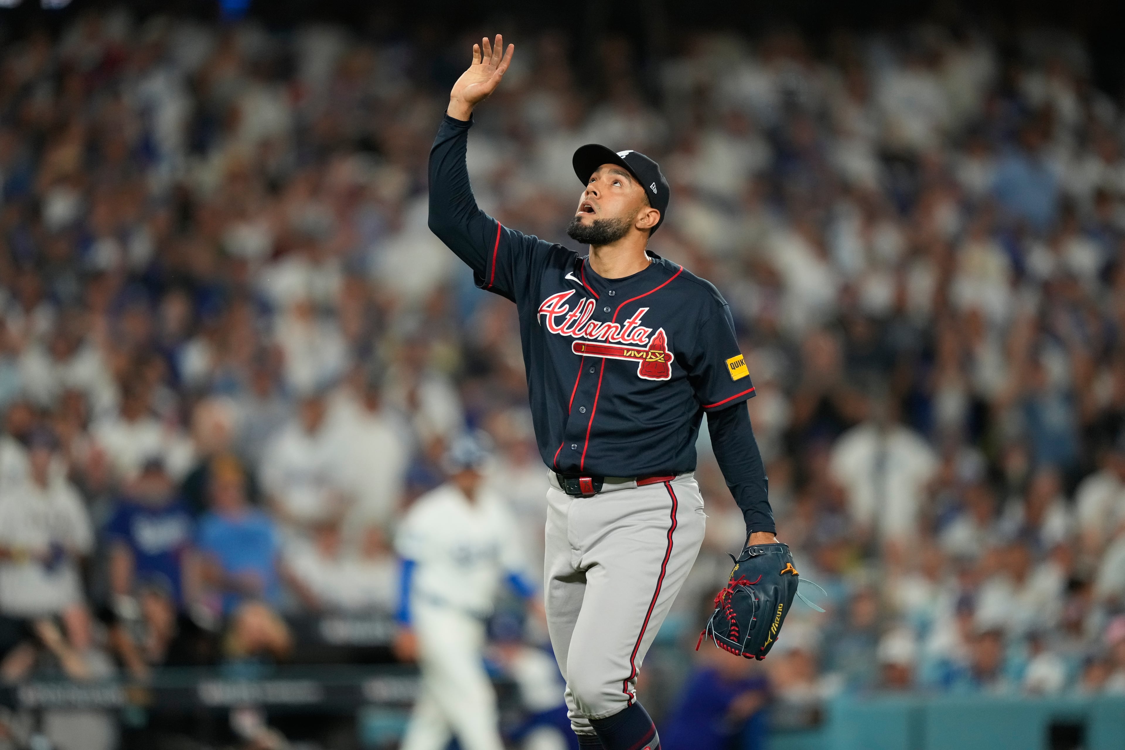 Atlanta Braves pitcher Robert Suarez reaches skyward at the end of the sixth inning of Game 2 of a National League Division Series baseball game against the Los Angeles Dodgers Sunday, Oct. 4, 2026, in Los Angeles. (AP Photo/Mark J. Terrill)