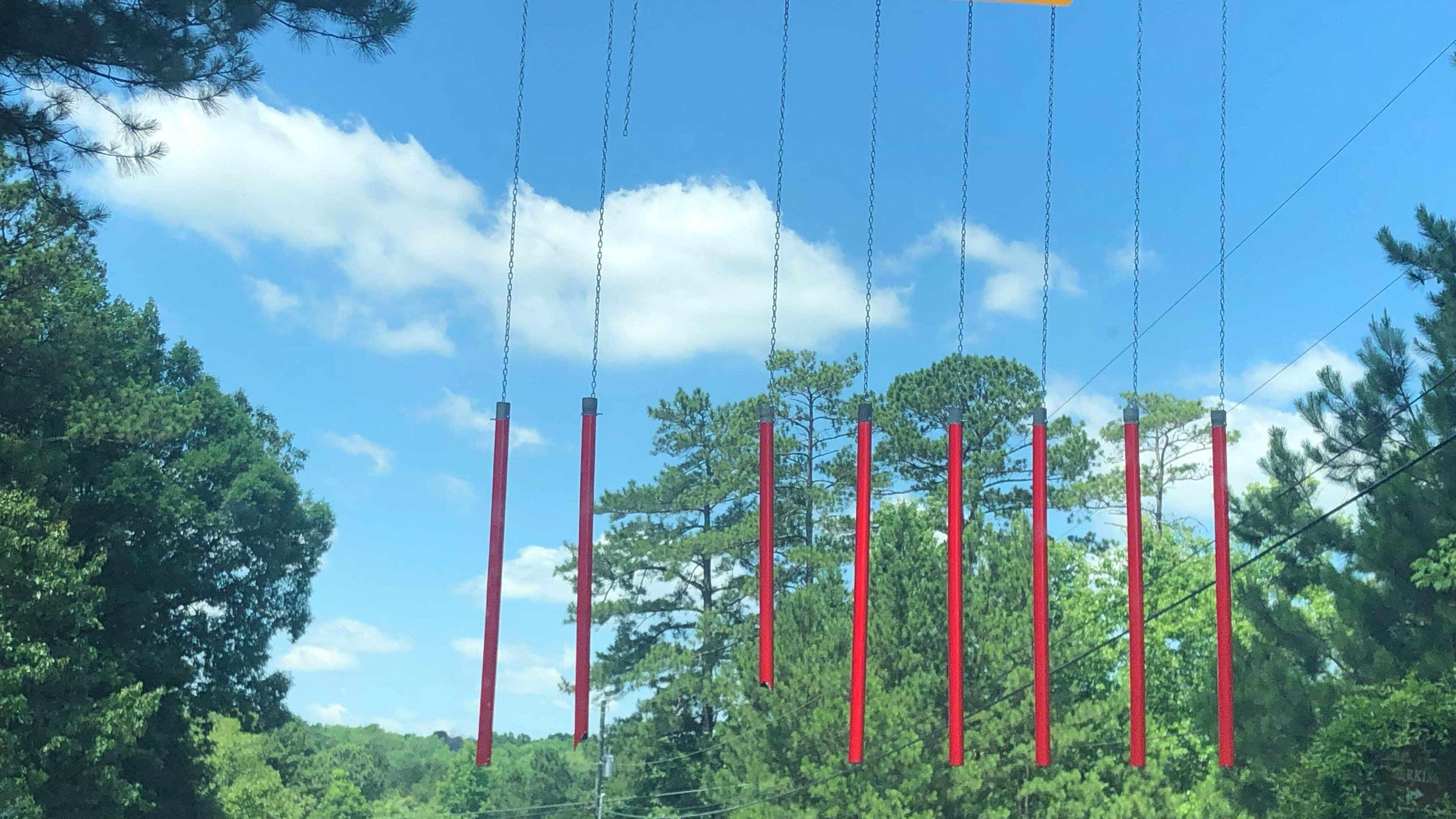 A truck smacked and took out one of the pipes suspended from a mast arm on the Smyrna side of the Concord Road covered bridge. The pipes and mast arms are the latest warning device installed by Cobb County to alert drivers to the bridge's seven-foot clearance. Photo: Kellie Meckes/For the AJC
