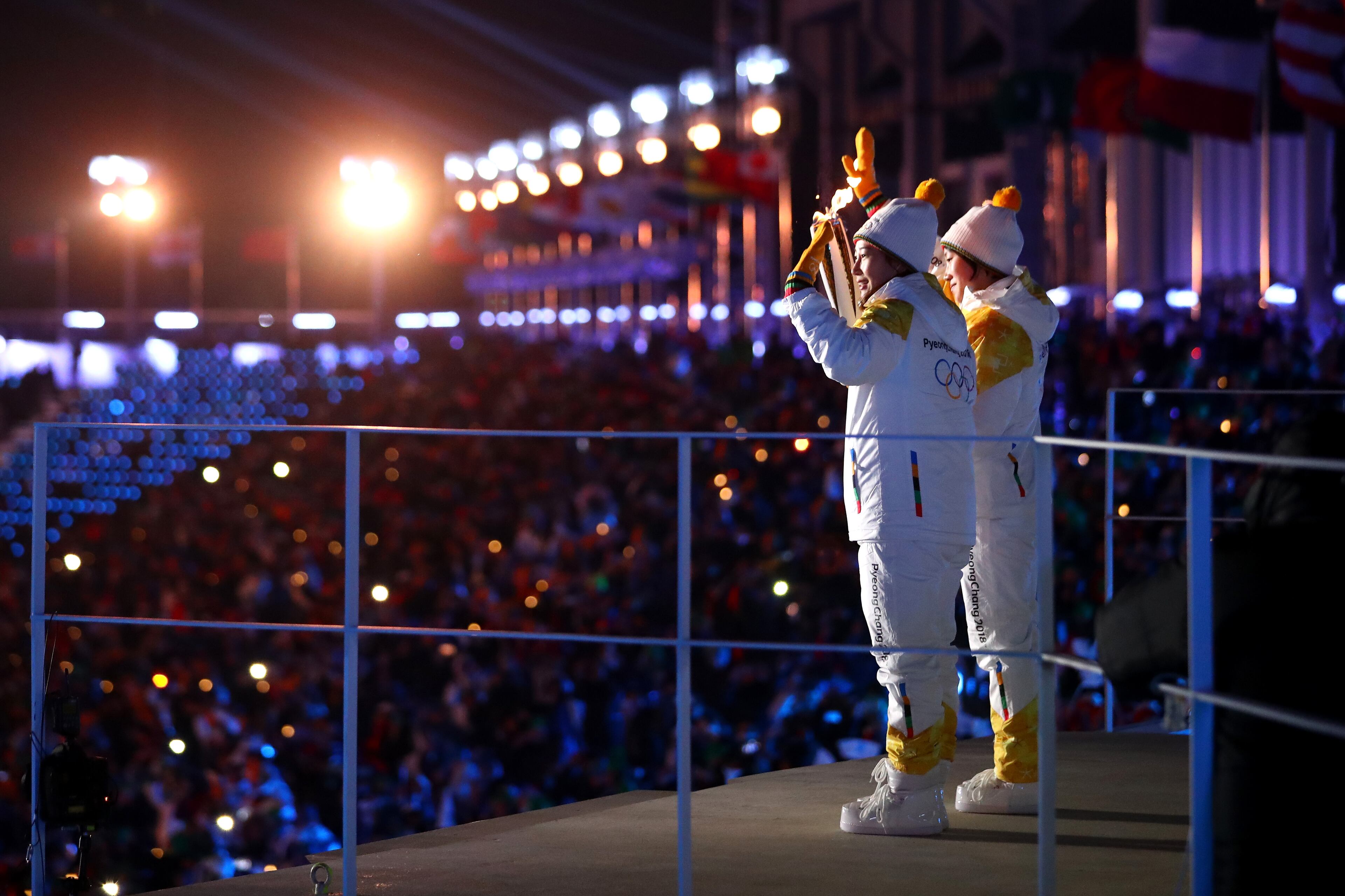 PYEONGCHANG-GUN, SOUTH KOREA - FEBRUARY 09: The carriers of The Olympic torch wave the the crowd during the Opening Ceremony of the PyeongChang 2018 Winter Olympic Games at PyeongChang Olympic Stadium on February 9, 2018 in Pyeongchang-gun, South Korea. (Photo by Dean Mouhtaropoulos/Getty Images)