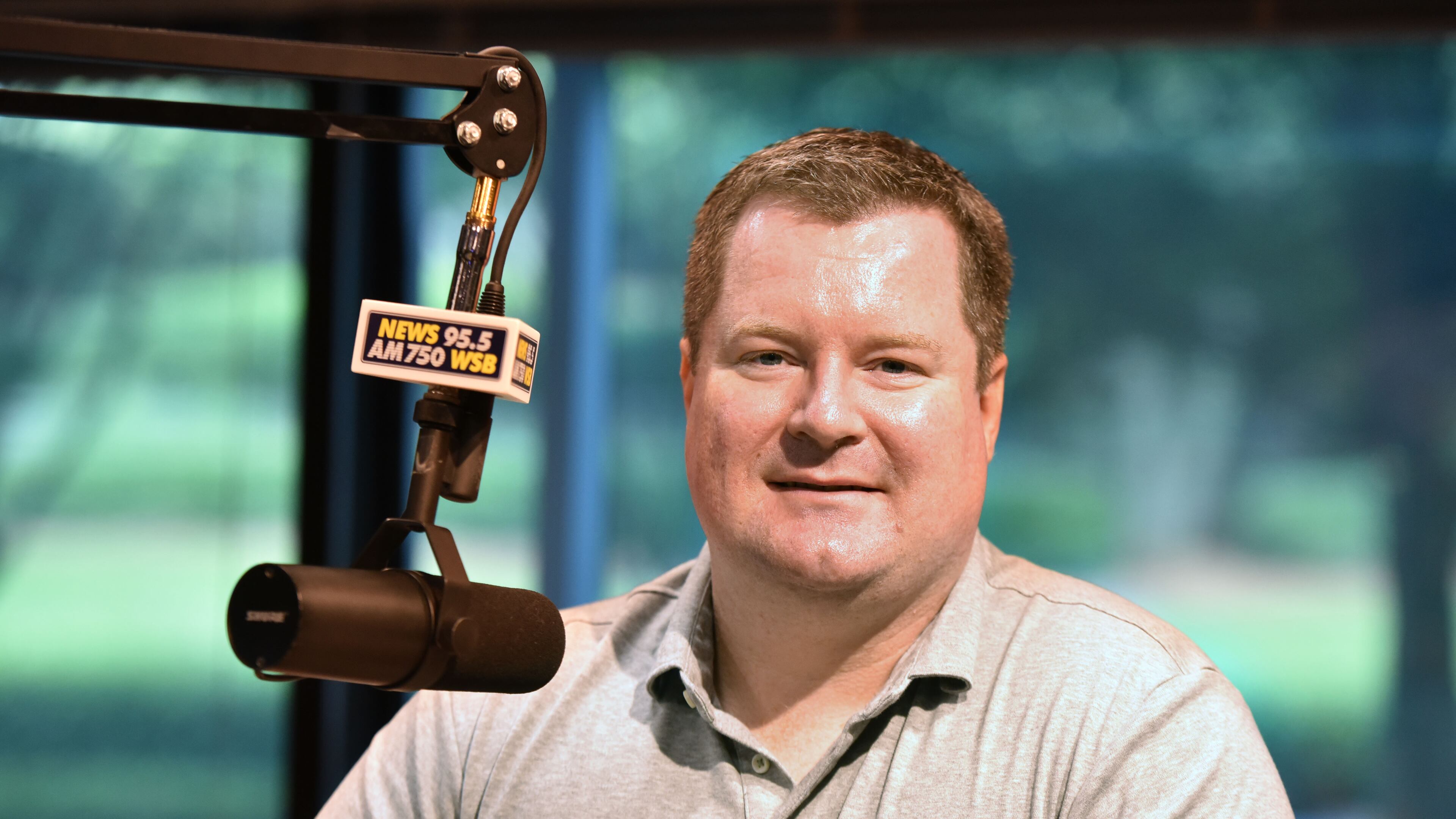 Erick Erickson at a studio mic at News 95.5 and AM750 WSB. He’s also the editor-in-chief of RedState.Com and will host next weekend’s gathering of GOP presidential candidates. Hyosub Shin, hshin@ajc.com