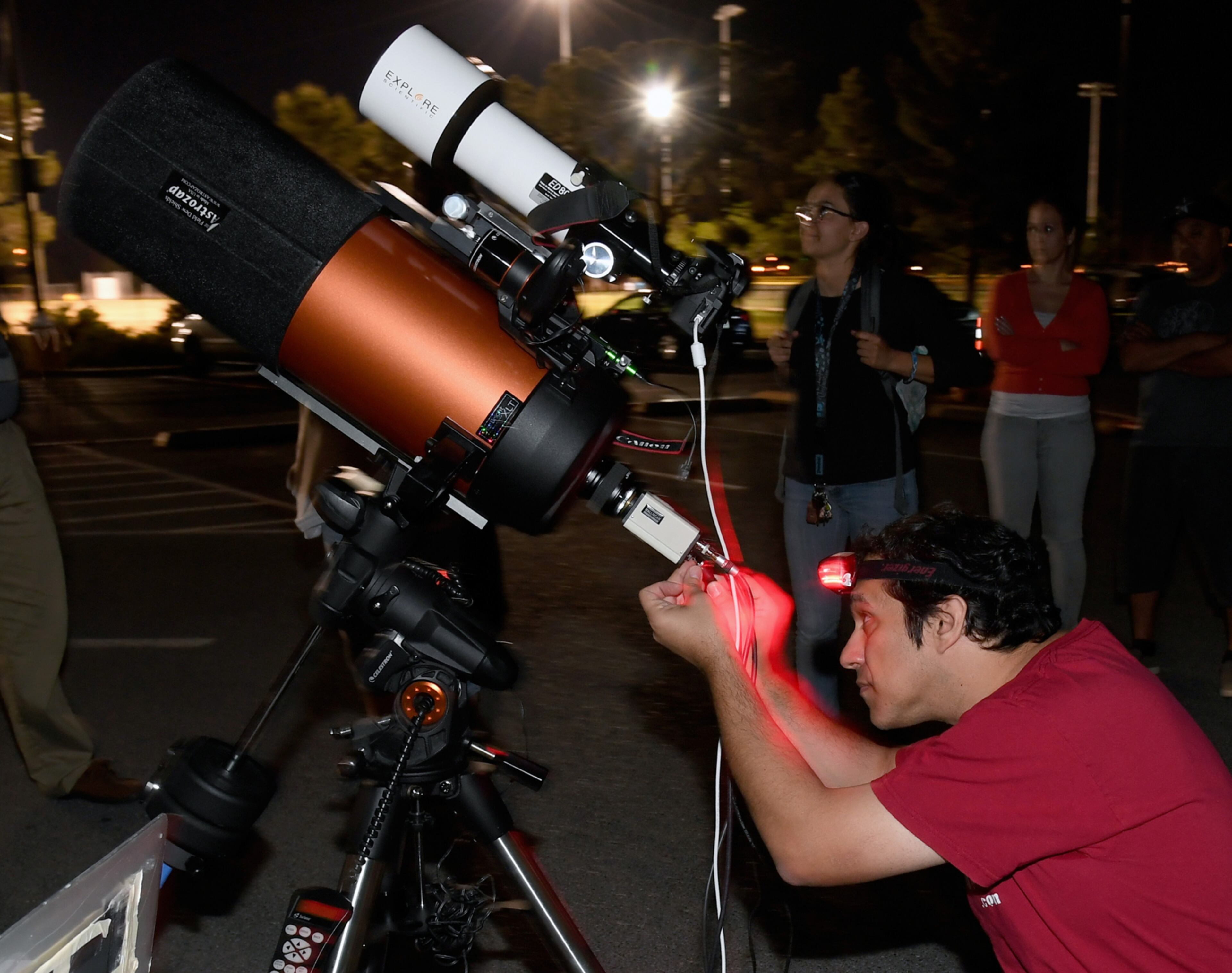 LAS VEGAS, NV - APRIL 19: Las Vegas Astronomical Society vice president of special events Keith Caceres sets up a telescope outside the Planetarium at the College of Southern Nevada to view asteroid 2014 JO25 on April 19, 2017 in Las Vegas, Nevada. The near mile-long asteroid is traveling at 75,000 mph as it passes the Earth's orbit at almost 1.1 million miles from Earth, less than five times the distance from the Earth to the moon. Astronomers at the Catalina Sky Survey in Arizona discovered the asteroid in May 2014, as part of NASA's Near-Earth Object (NEO) Observations Program. It is a contact binary asteroid (two connected rock lobes that were originally separate) giving it a peanut-like shape and is the closest any asteroid this large has approached Earth since September 2004. (Photo by Ethan Miller/Getty Images)