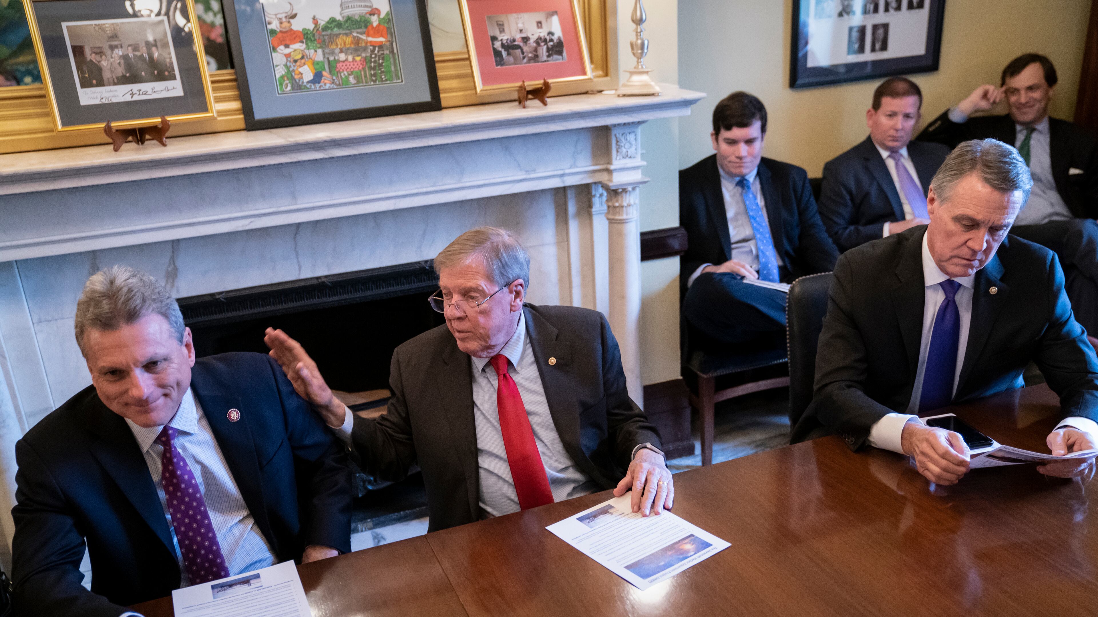 Sen. Johnny Isakson, R-Ga., flanked by Rep. Buddy Carter R-Ga., left, and Sen. David Perdue, R-Ga., right, leads a meeting with the Georgia Ports Authority and the Army Corps of Engineers about the budget for the Savannah Harbor Expansion Project on Feb. 14, 2019. (AP Photo/J. Scott Applewhite)