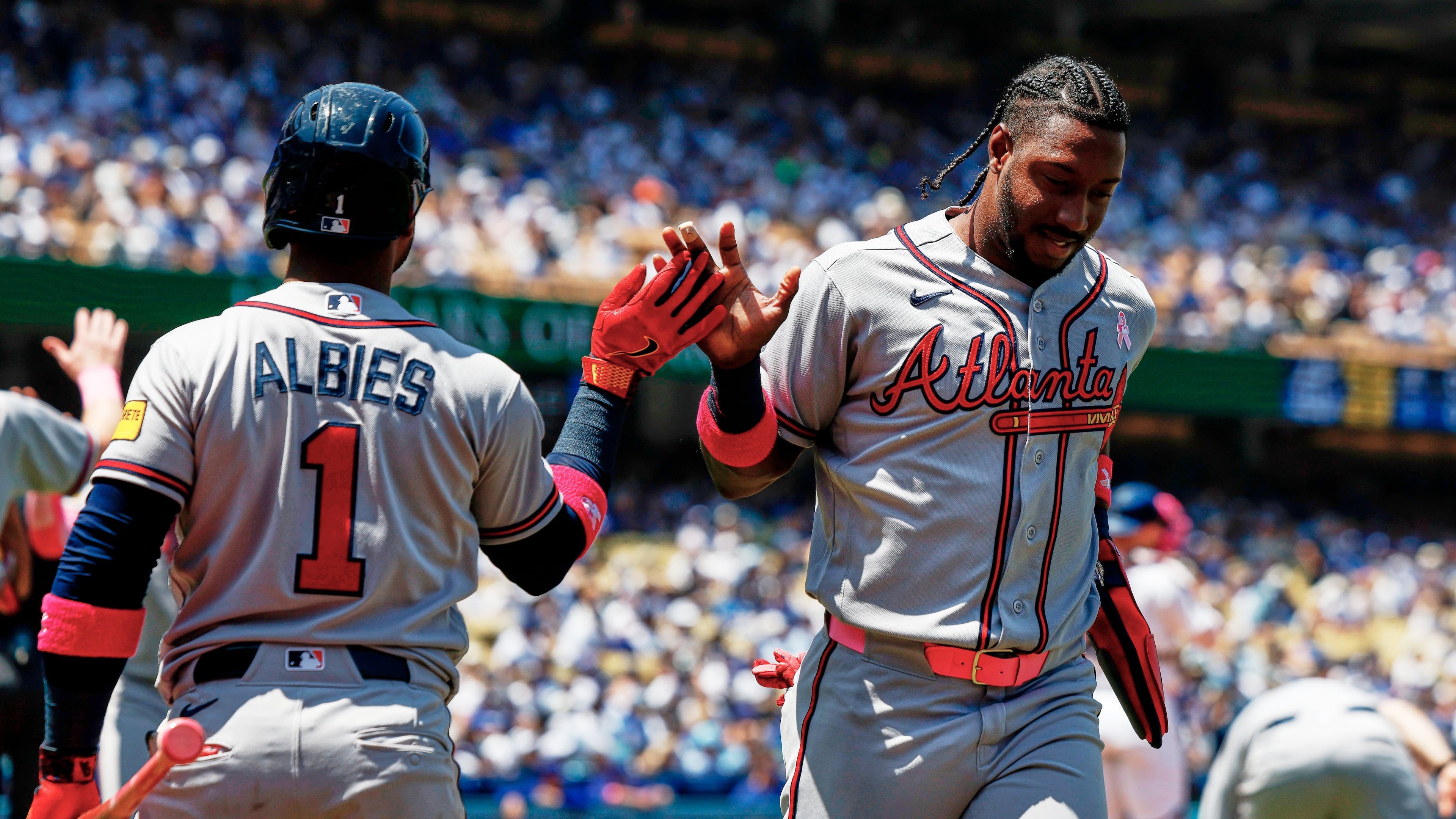 Atlanta Braves' Jorge Mateo, right, is greeted by Ozzie Albies (1) on a a two-run double by Atlanta Braves' Mauricio Dubon during the second inning of a baseball game against the Los Angeles Dodgers, Sunday, May 10, 2026, in Los Angeles. (AP Photo/Caroline Brehman)