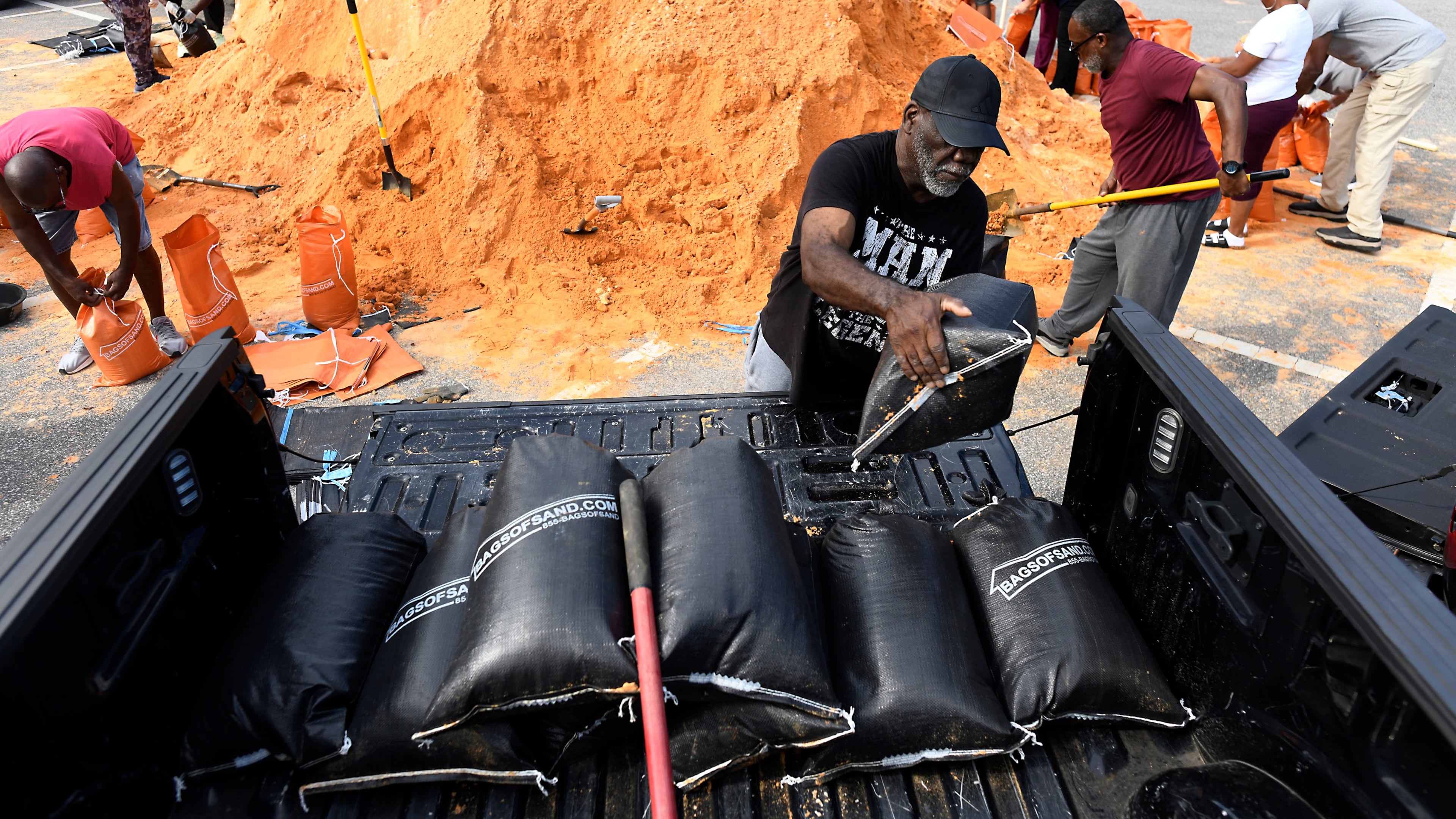 Residents pick up sandbags for storm preparation at the James Seals Jr. Parks & Recreation Center ahead of Hurricane Isaias' expected landfall along the Gulf Coast, Thursday, Oct. 8, 2026, in Mobile, Ala. (AP Photo/Octavio Jones)
