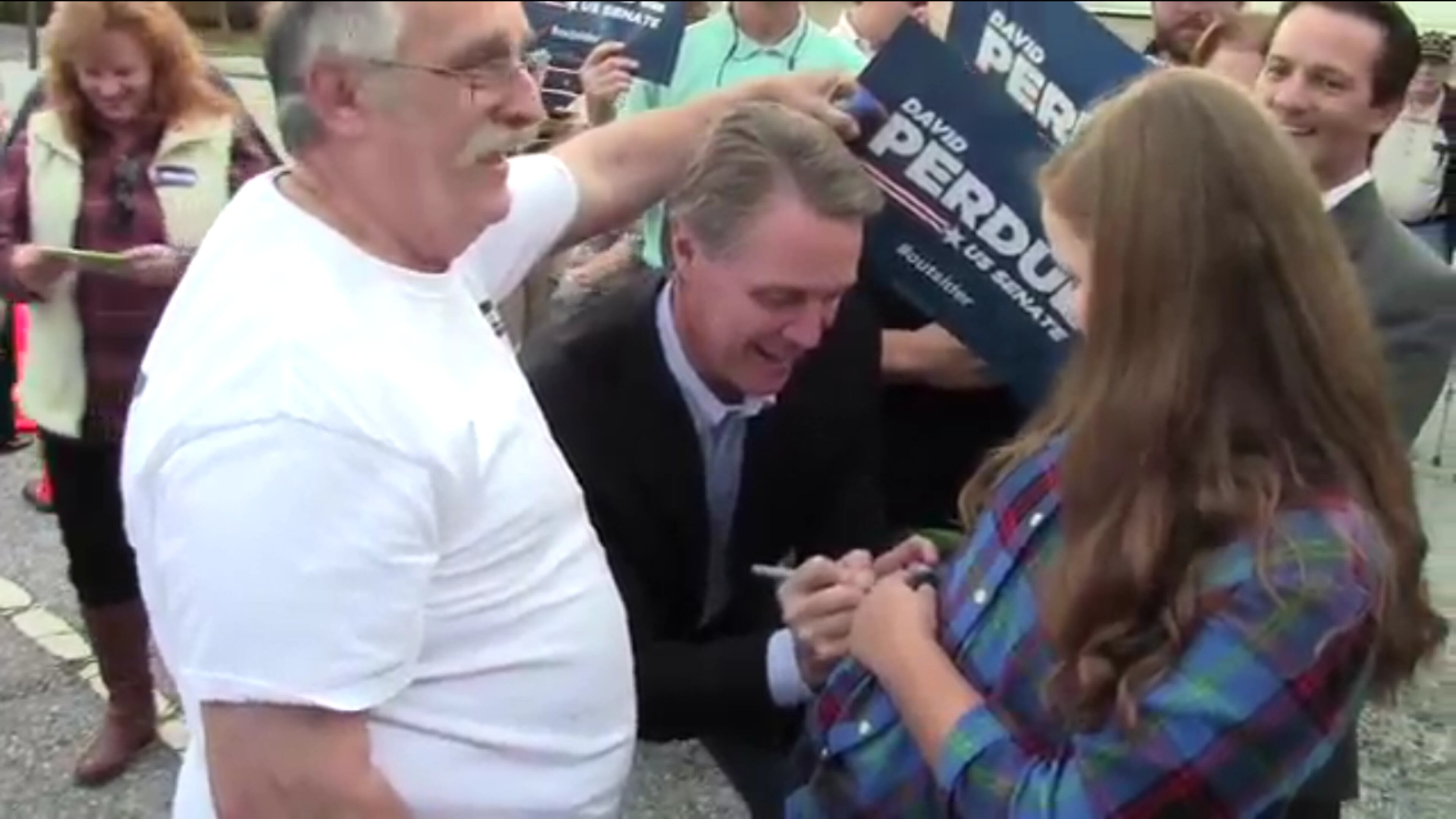 A screenshot from the second David Perdue signature video