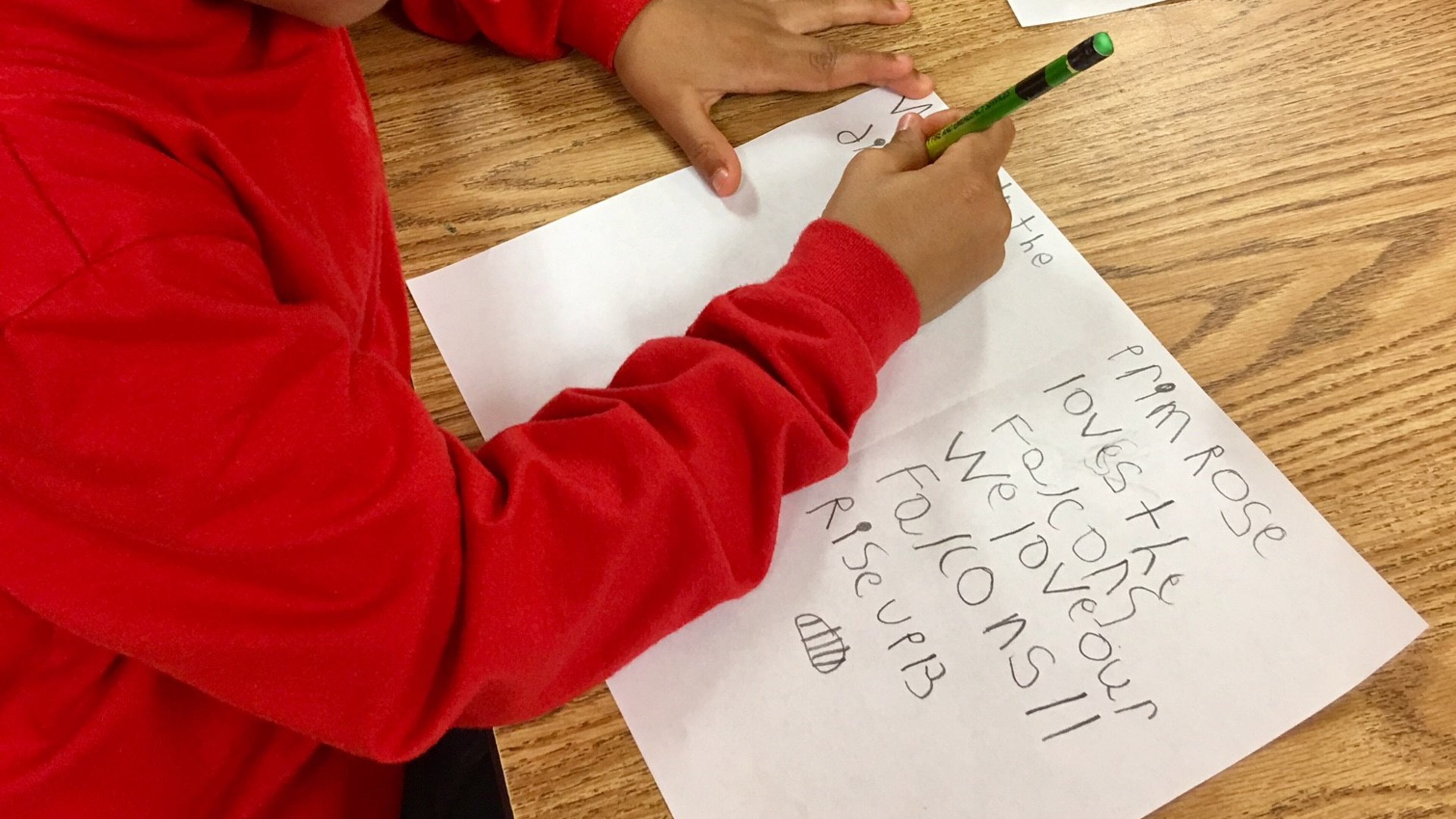 A Primrose School of Buford student writes a card for Falcons players following their Super Bowl loss.