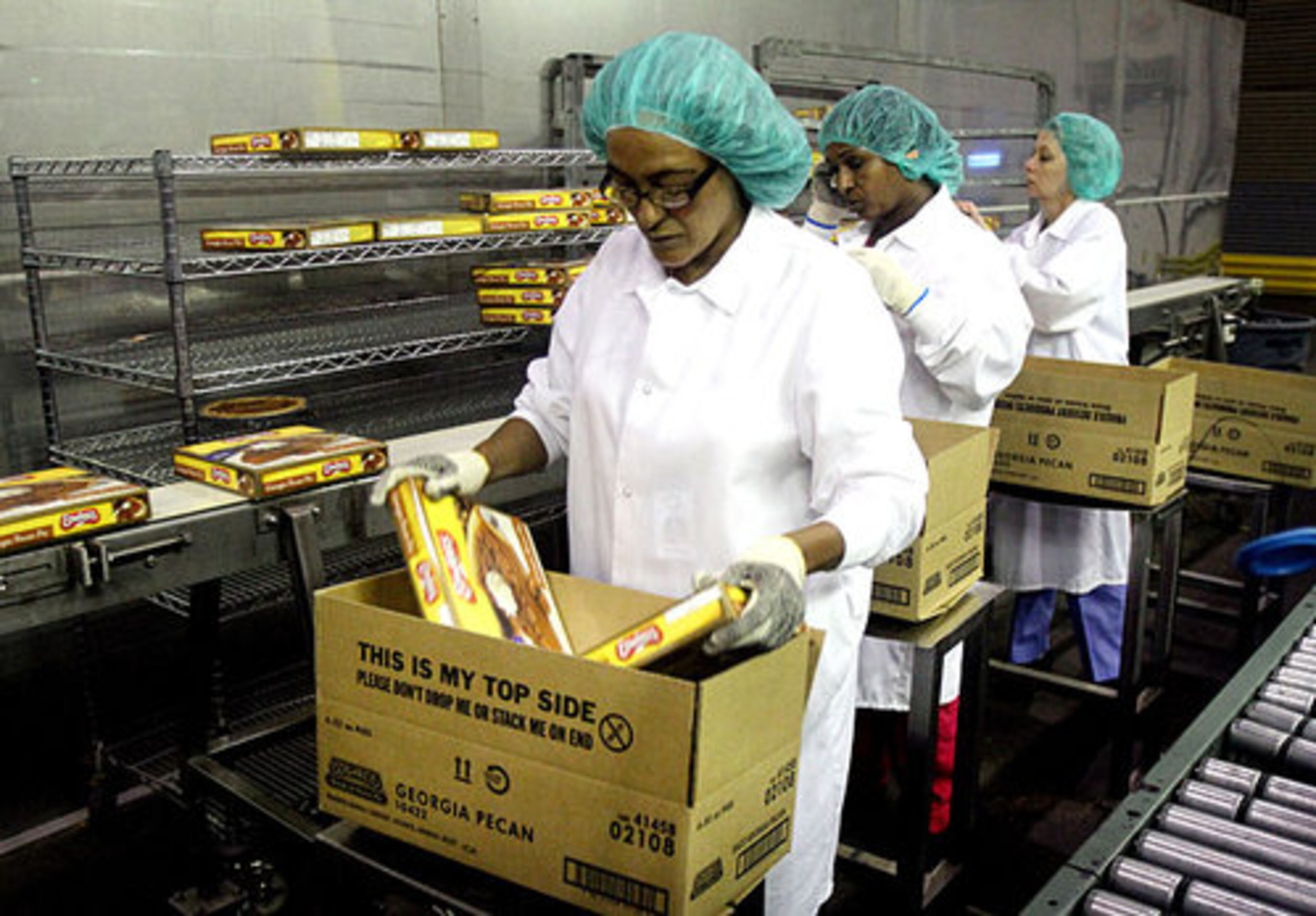 Zebideru Guluma, left, Almaz Makennon & Mayra Zambrana package pecan pies for shipping.