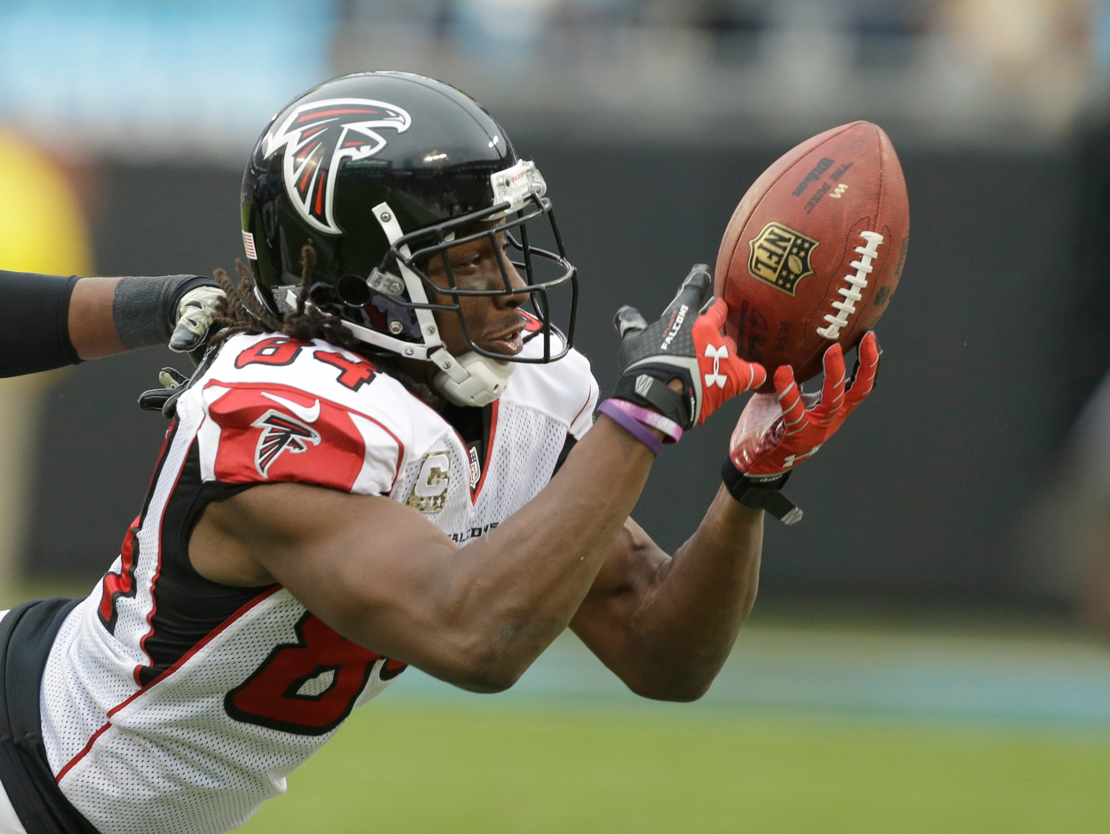 Atlanta Falcons' Roddy White (84) just misses catching a pass against the Carolina Panthers in the second half of an NFL football game in Charlotte, N.C., Sunday, Nov. 16, 2014. (AP Photo/Bob Leverone)
