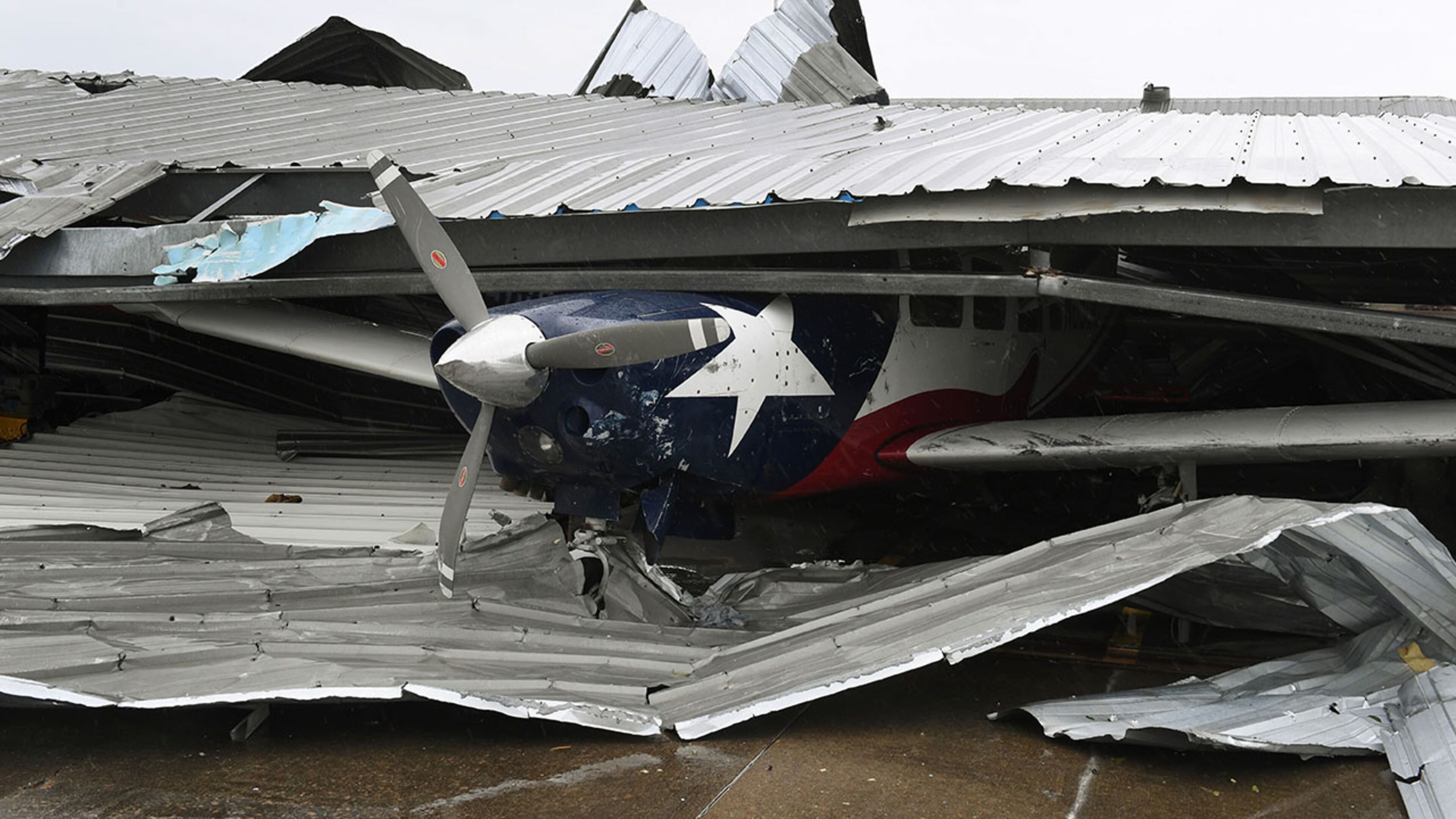 A badly damaged light plane in its hanger at Rockport Airport after heavy damage when Hurricane Harvey hit Rockport, Texas on August 26, 2017.
Hurricane Harvey slammed into the Texas coast late Friday, unleashing torrents of rain and packing powerful winds, the first major storm to hit the US mainland in 12 years. / AFP PHOTO / MARK RALSTON (Photo credit should read MARK RALSTON/AFP/Getty Images)